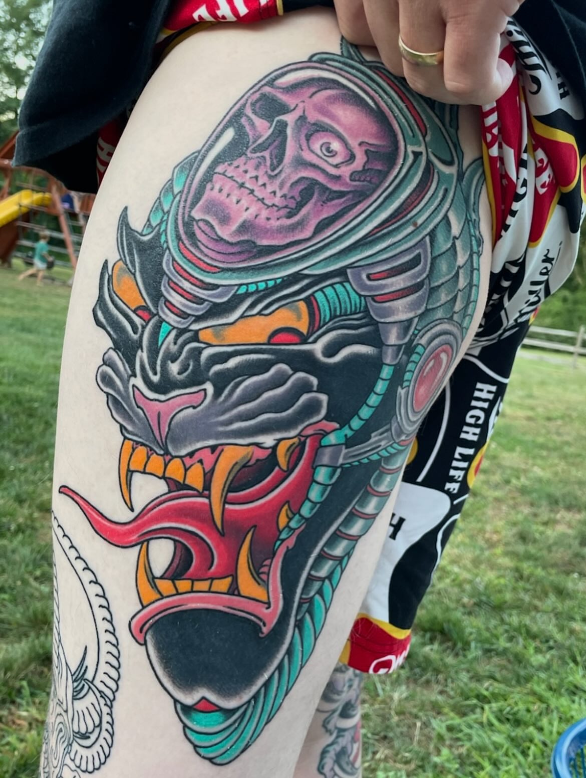Skull in helmet American traditional tattoo on the thigh by Billy Haines