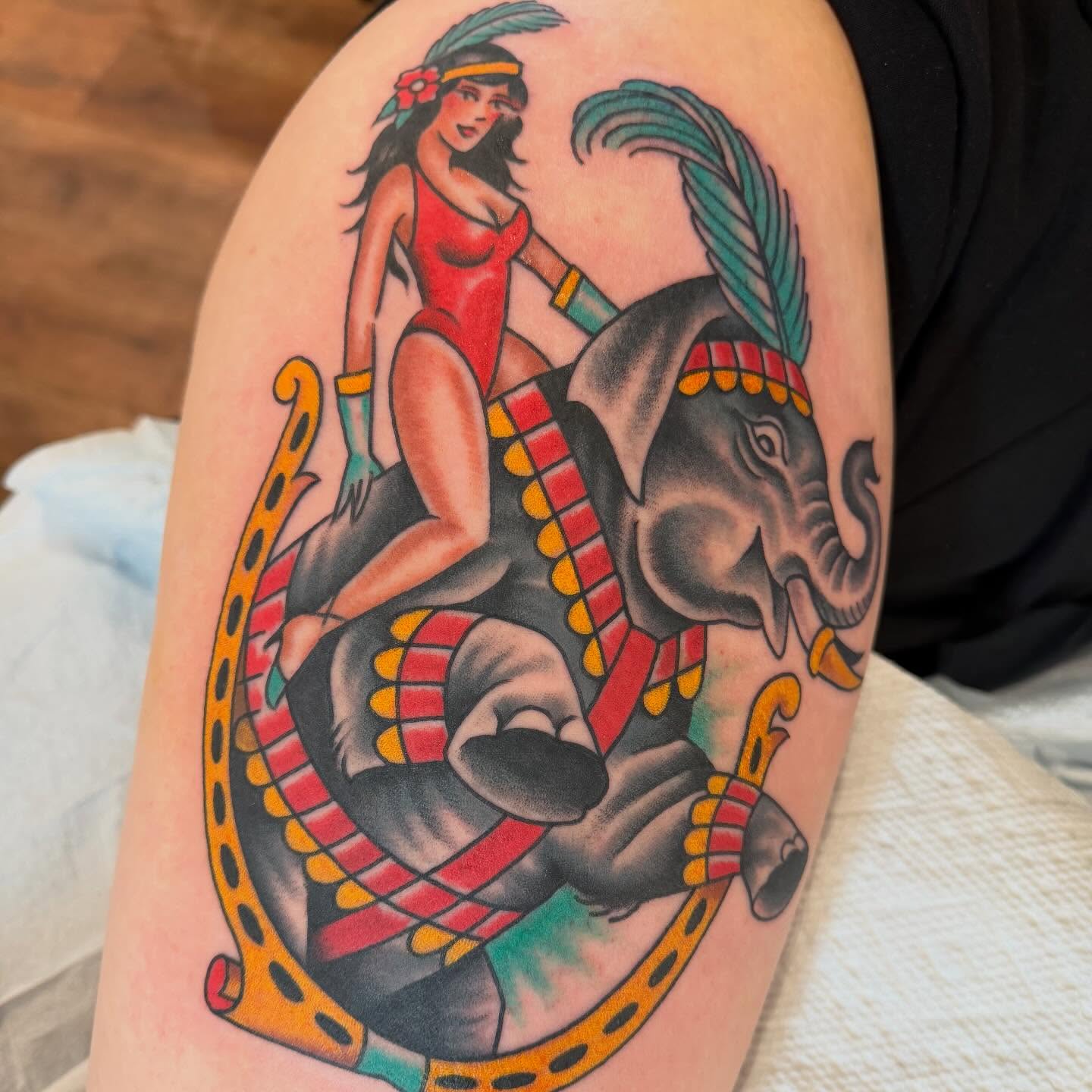 Woman riding elephant American traditional tattoo on the upper arm by Grandma Approved, Chicago, Illinois