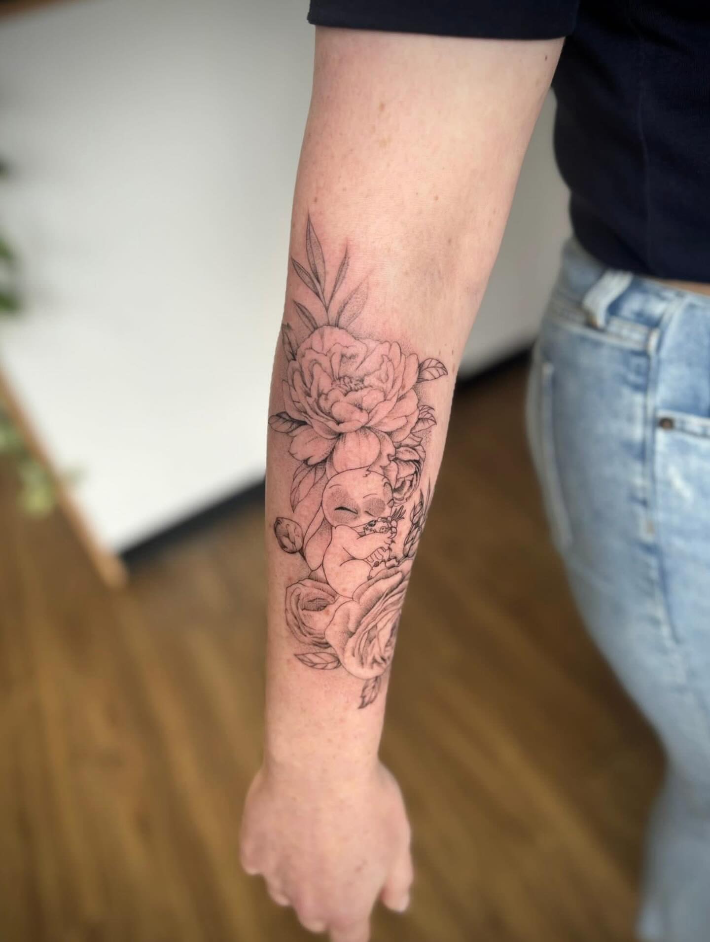 Baby and flowers black and grey tattoo on the forearm by Harley Lane ๐ซ
