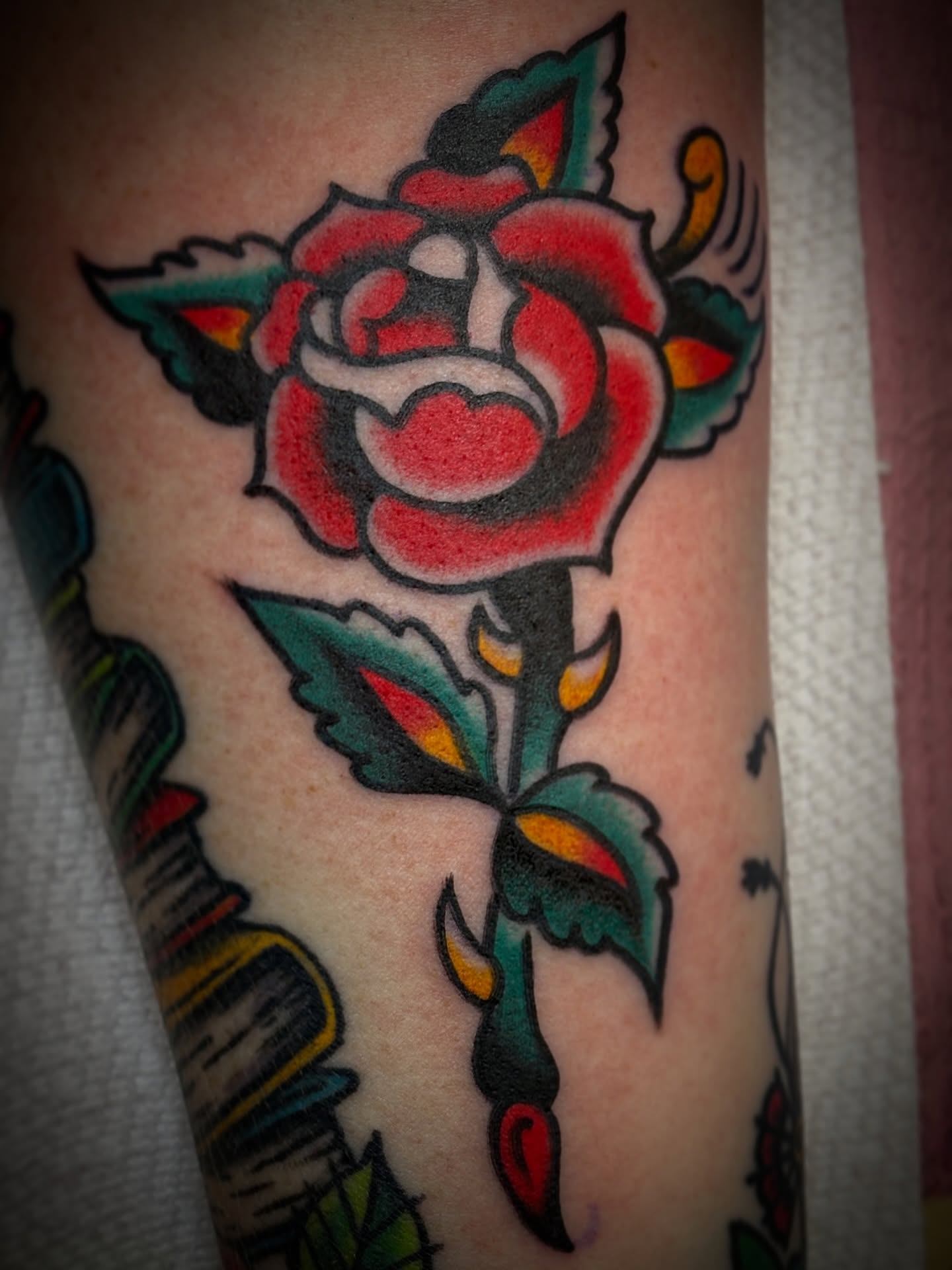 Rose American traditional tattoo on the forearm by Carlos Gonzalez Tattoo, Dallas, Texas