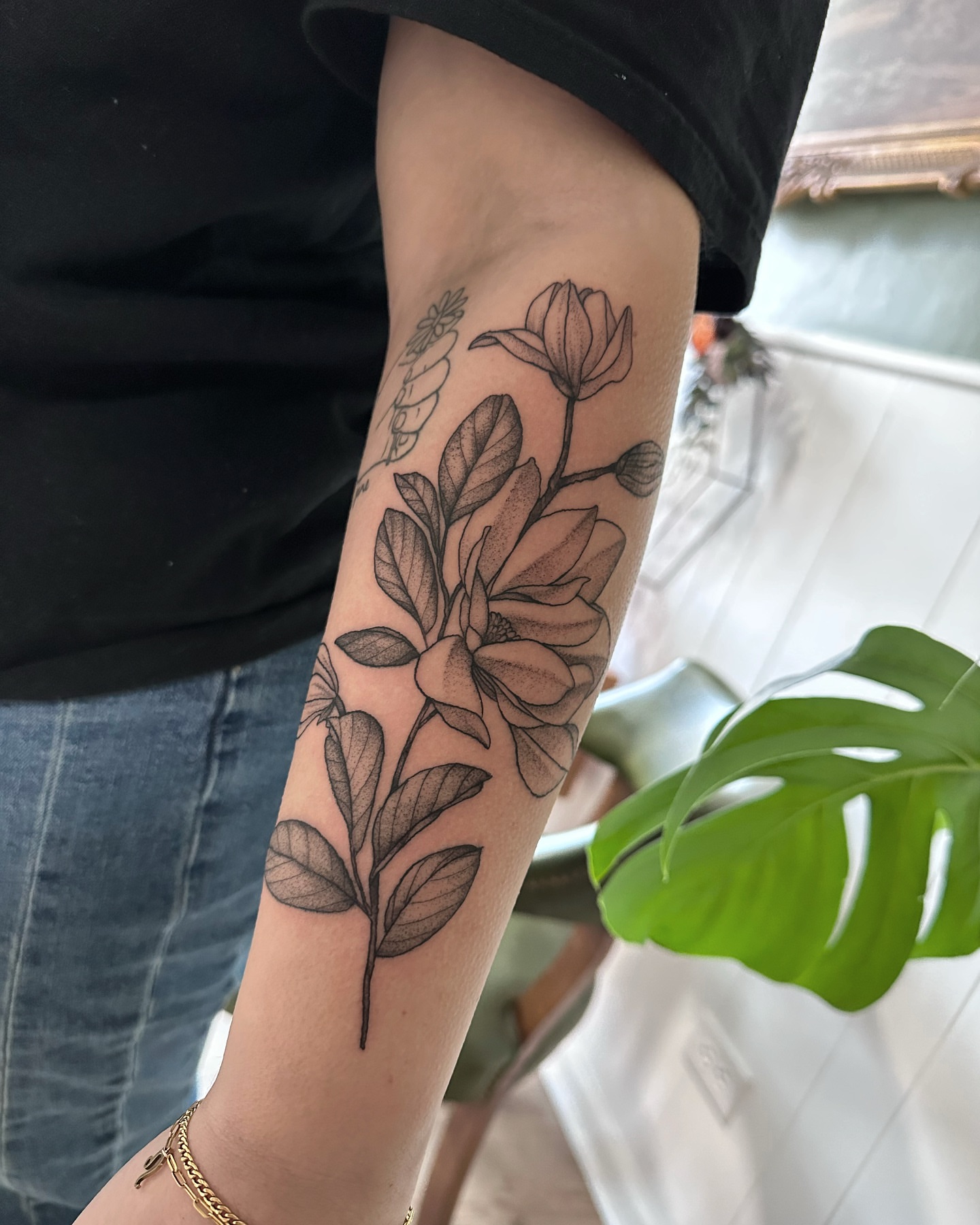 Magnolia flower black and grey tattoo on the forearm by Allexis
