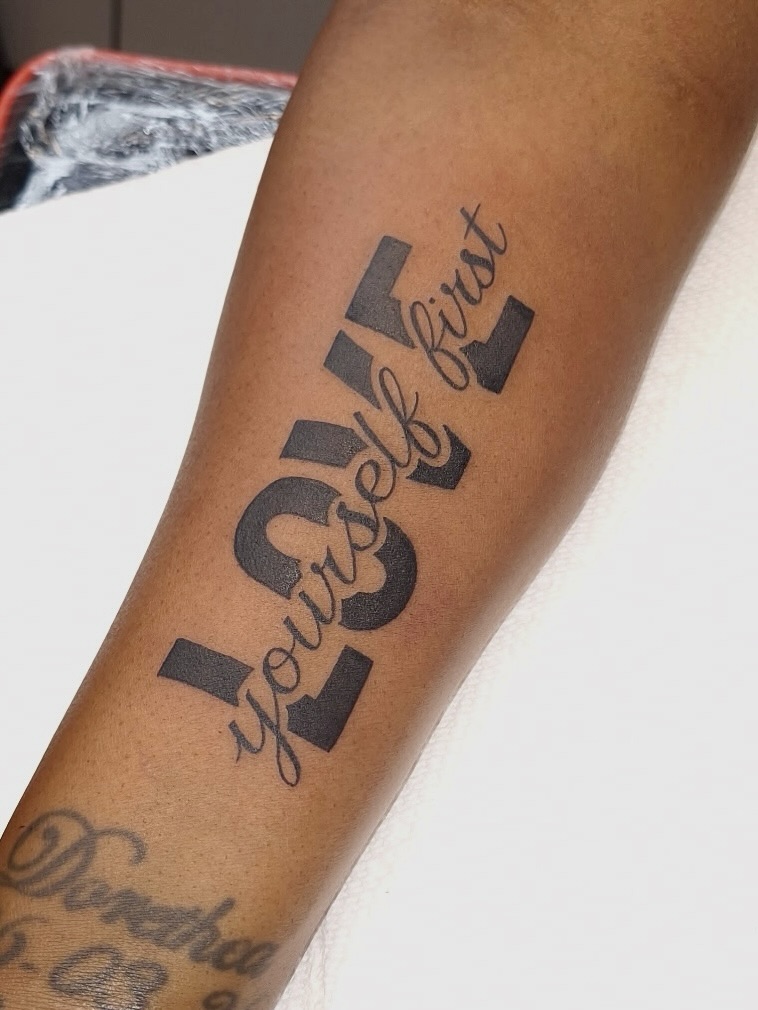LOVE yourself first lettering tattoo on the forearm by InkDex Collective