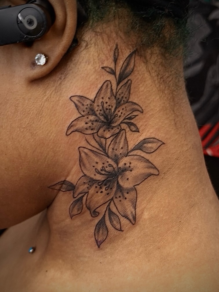 Lilies fine line tattoo on the neck by InkDex Collective