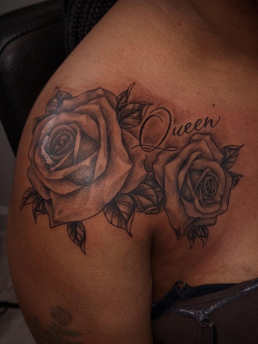 Roses and script lettering dotwork tattoo on the shoulder by InkDex Collective