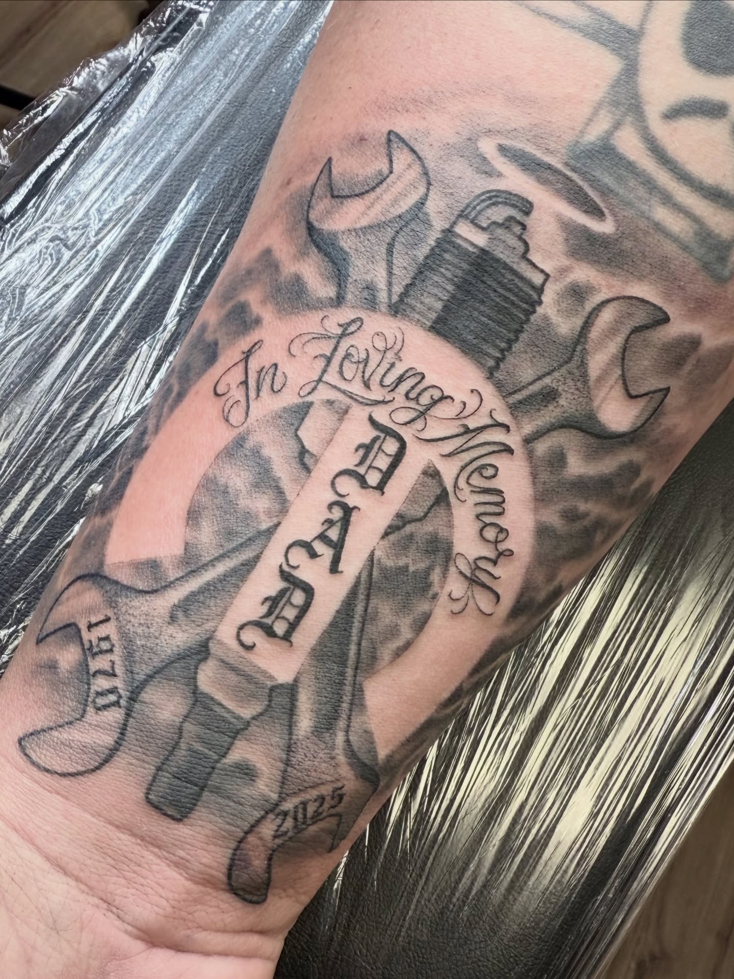Spark plug and wrench black and grey tattoo on the forearm by Gilberto Flores Nava
