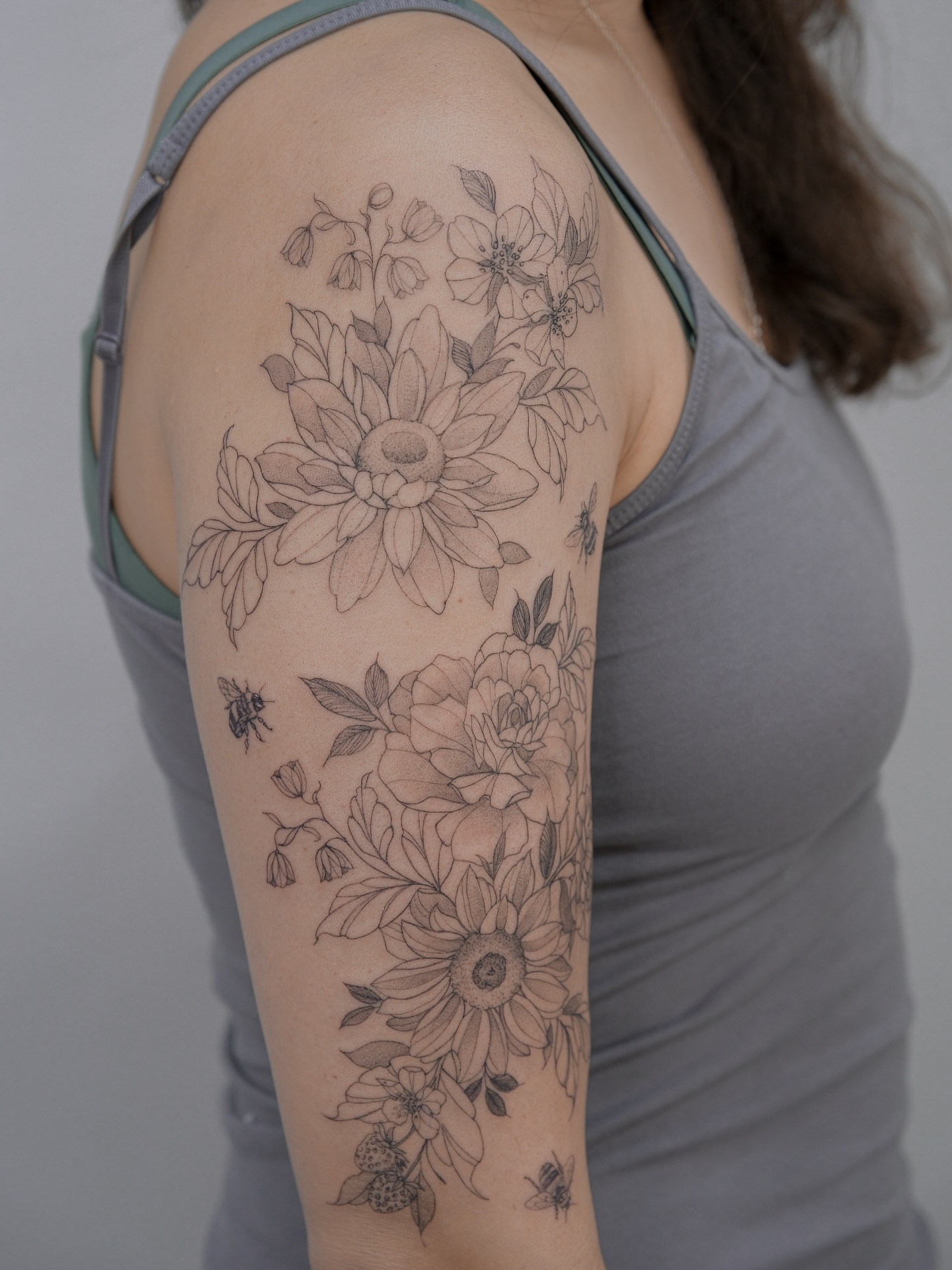 Floral bouquet realism tattoo on the upper arm by Tattoo in Charlotte NC, Charlotte, North Carolina