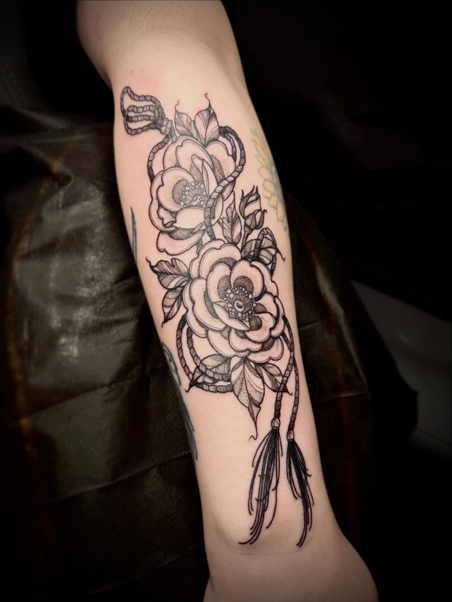 Roses and dreamcatcher realism tattoo on the forearm by 🏵