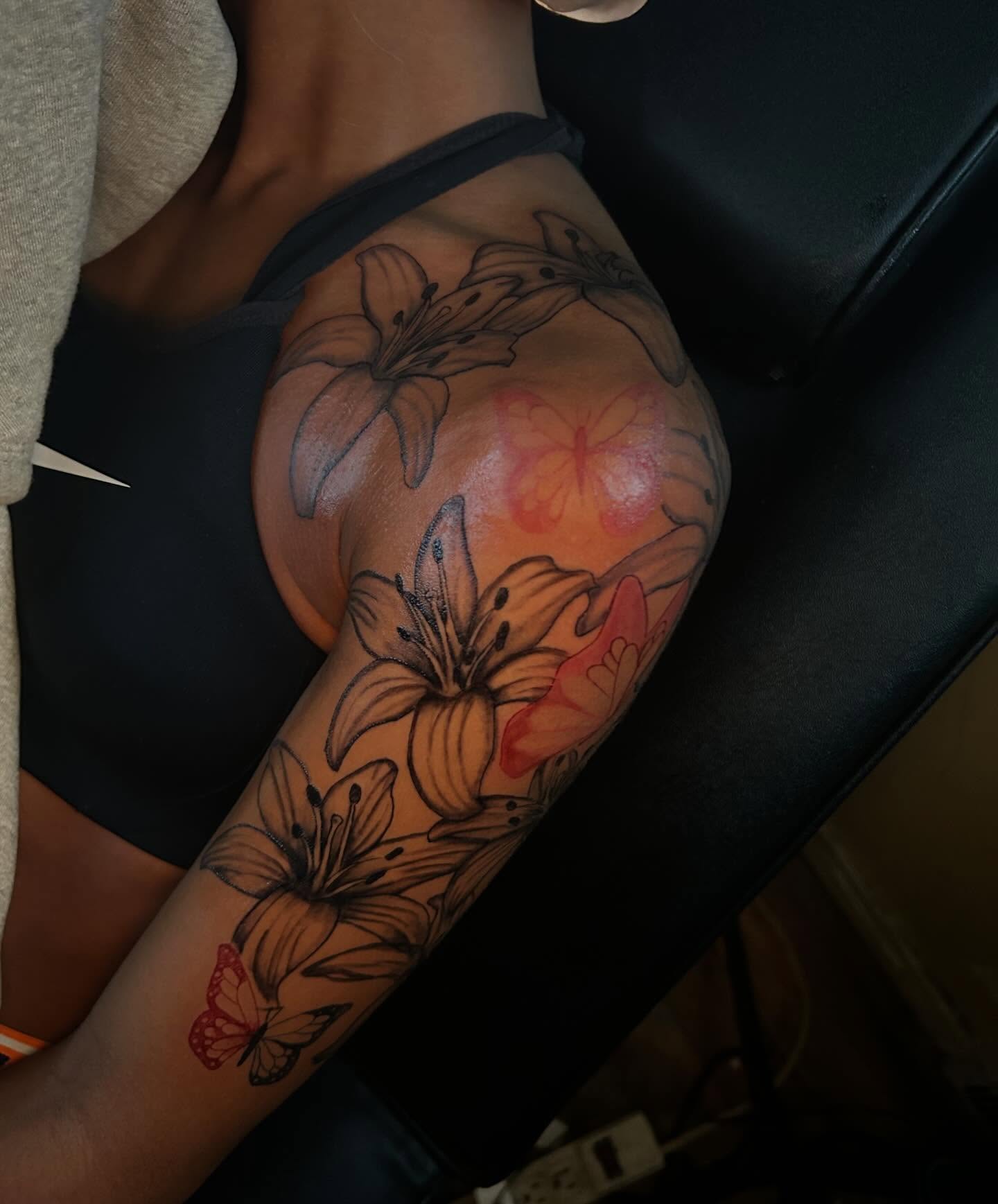 Lilies and butterflies new school tattoo on the thigh by Detroit tattoo Artist