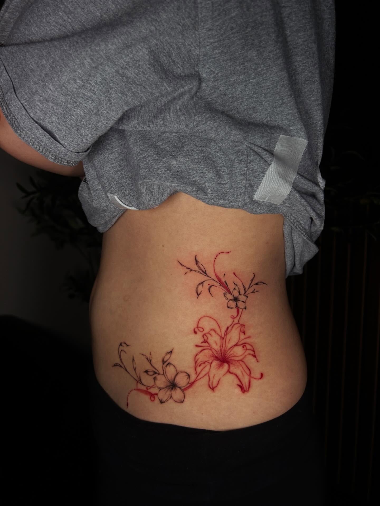 Lily and flowers new school tattoo on the torso by J
