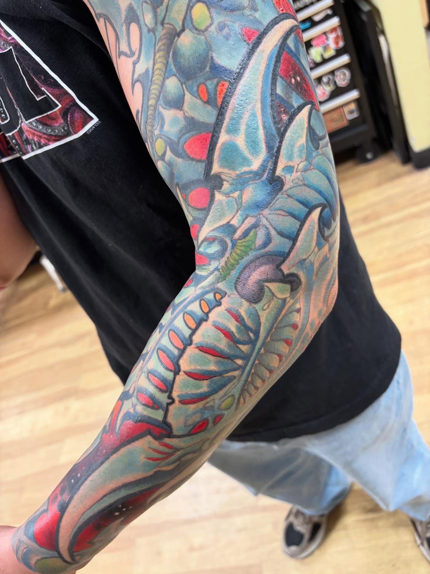 Abstract floral new school tattoo on the forearm by Rene Chavira