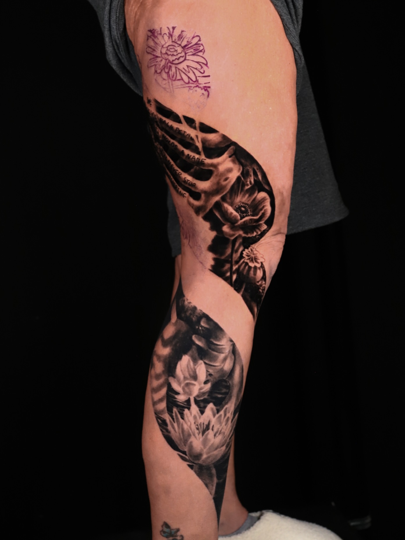 Skeleton and flowers realism tattoo on the forearm by Ava Grace