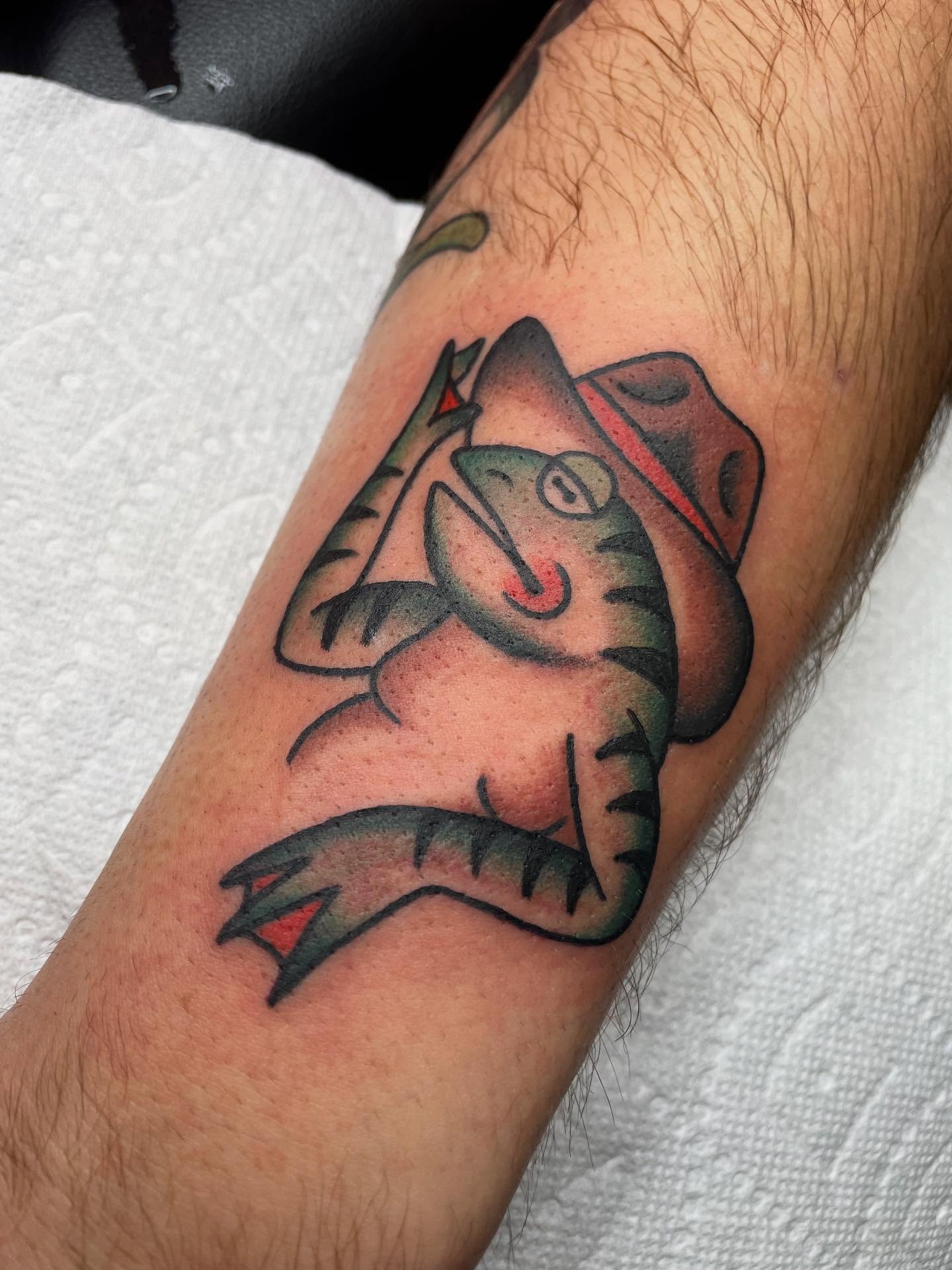Cat wearing hat American traditional tattoo on the forearm by Kat, Sacramento, California