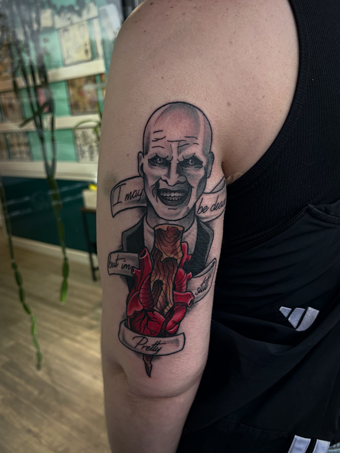 Man with heart realism tattoo on the upper arm by Bunny Noel