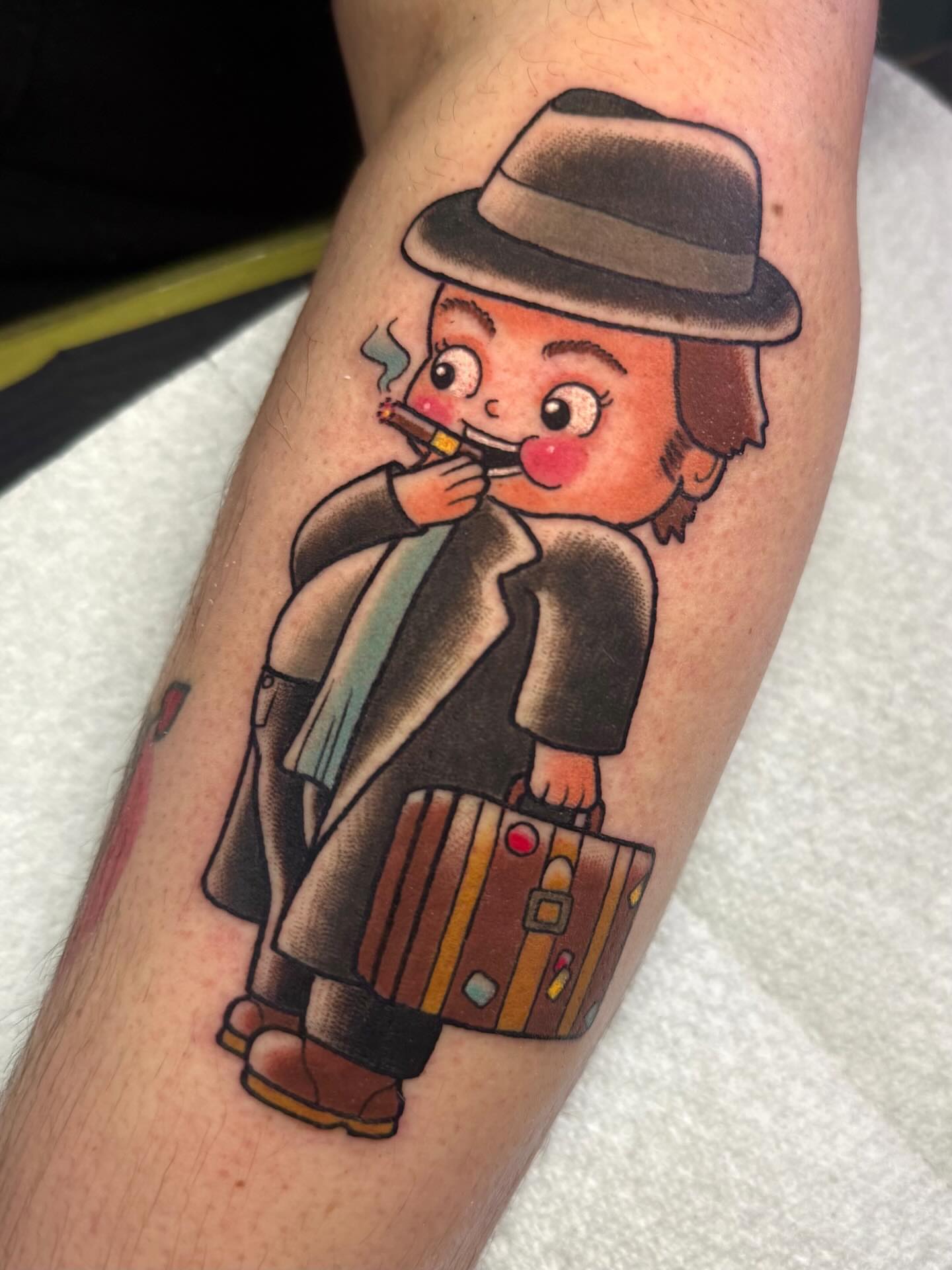 Cartoon detective American traditional tattoo on the forearm by 𝔎𝔦𝔯𝔞 𝔅𝔦𝔰𝔥𝔬𝔭