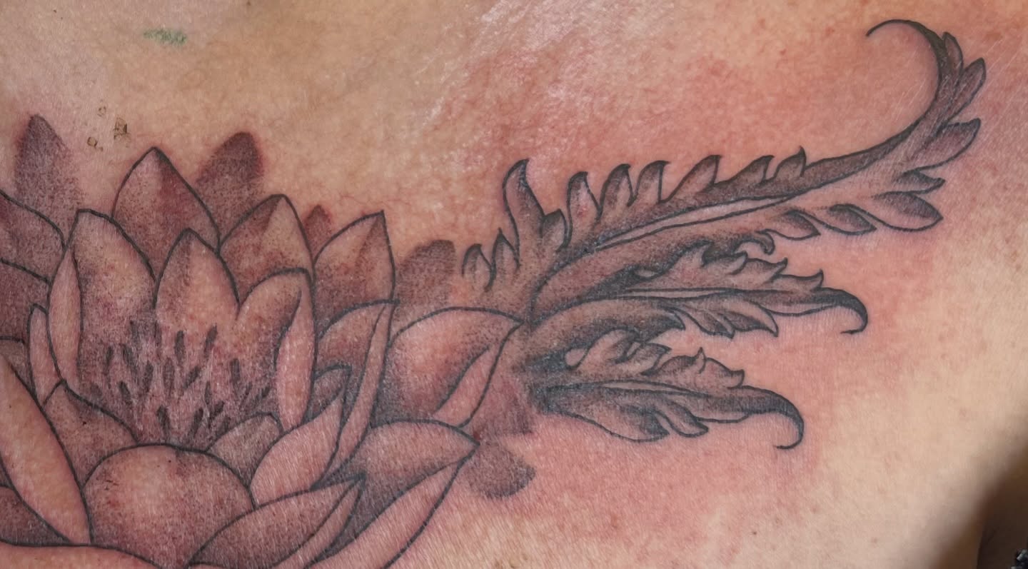 Flower and leaves black and grey tattoo on the chest by Dani McBay
