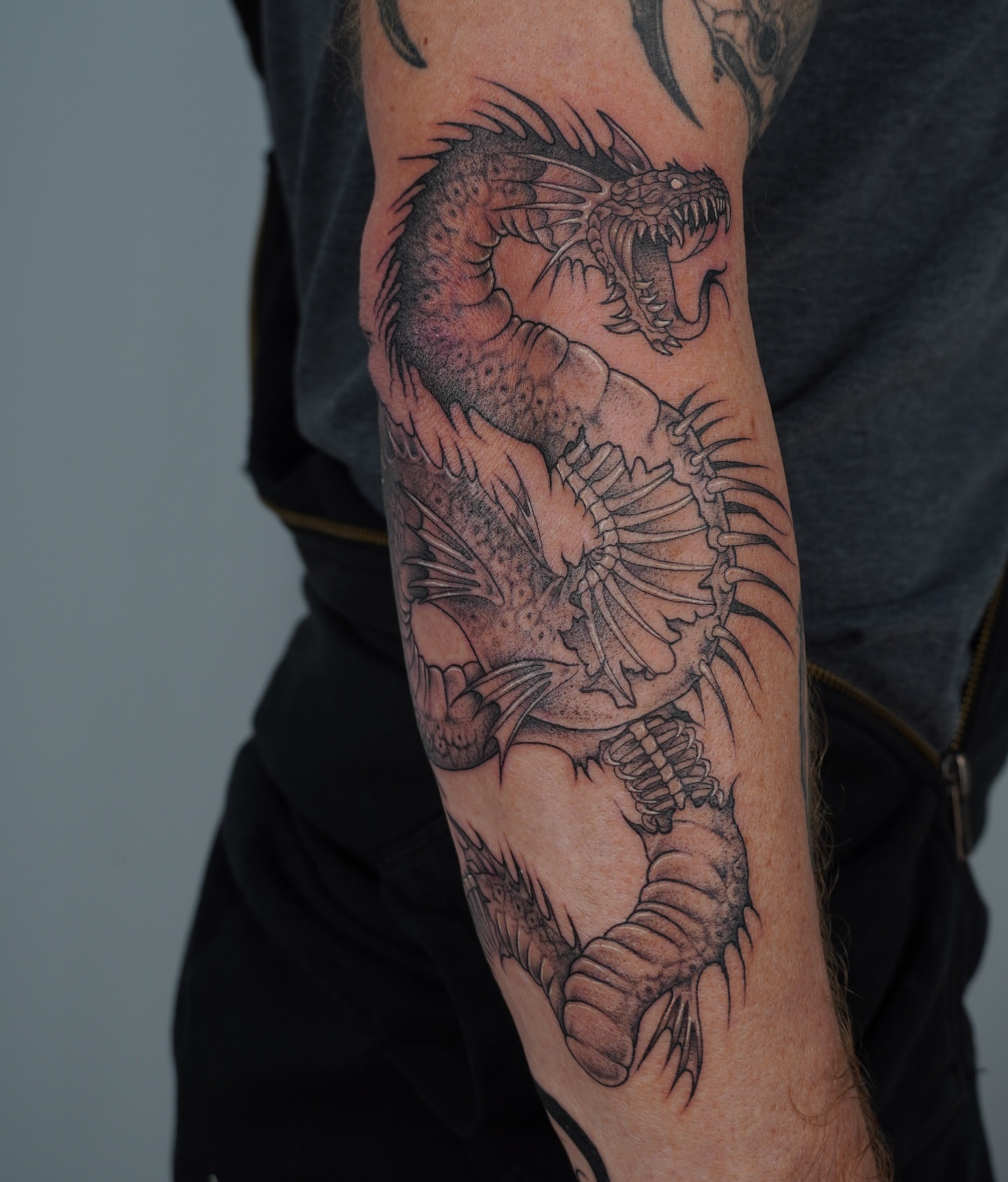 Dragon black and grey tattoo on the forearm by Cory Perry-Servellon