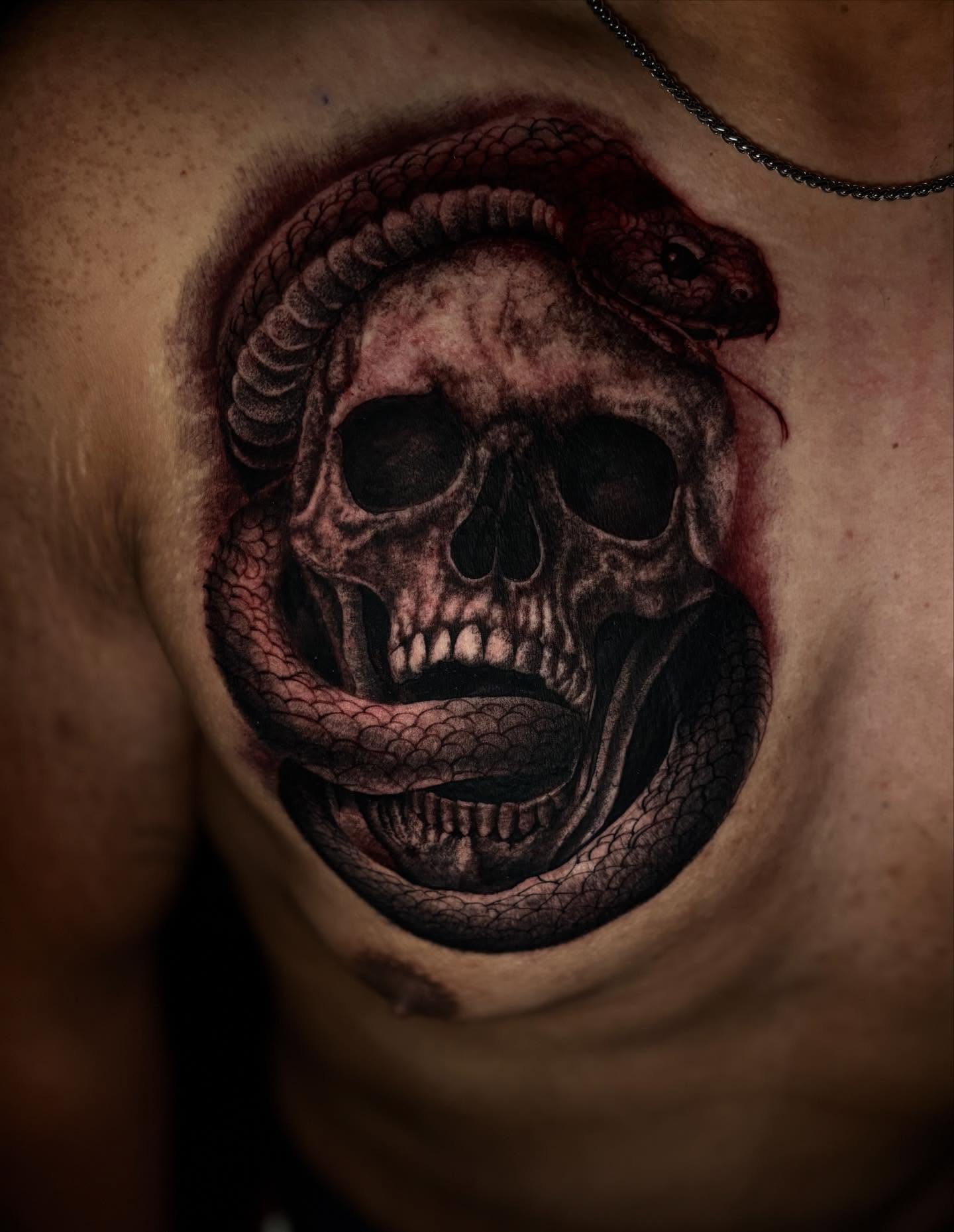 Skull and snake dark realism tattoo on the chest by @_frankyvee