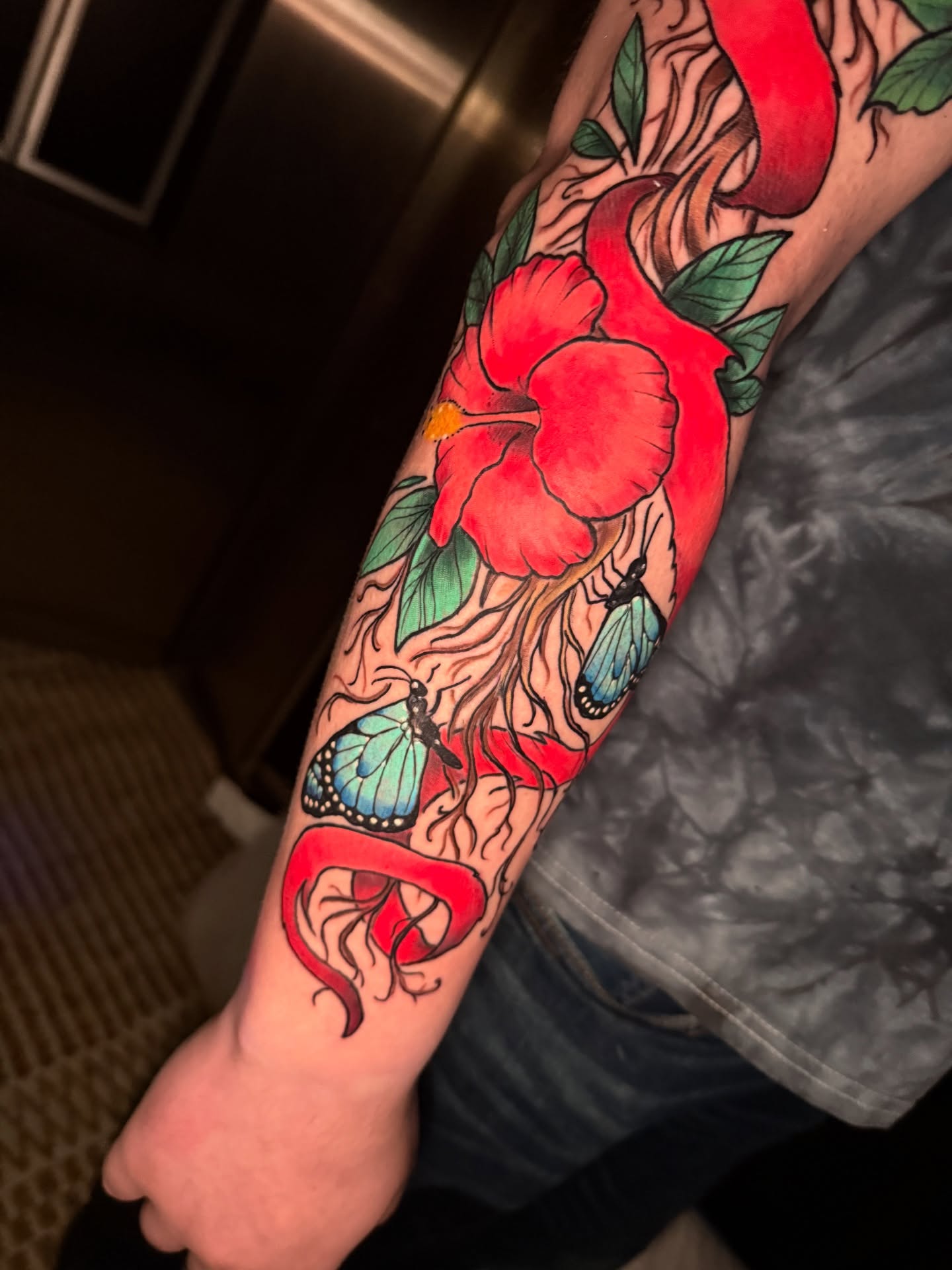 Hibiscus flower and butterflies new school tattoo on the forearm by Paul Endres Jr