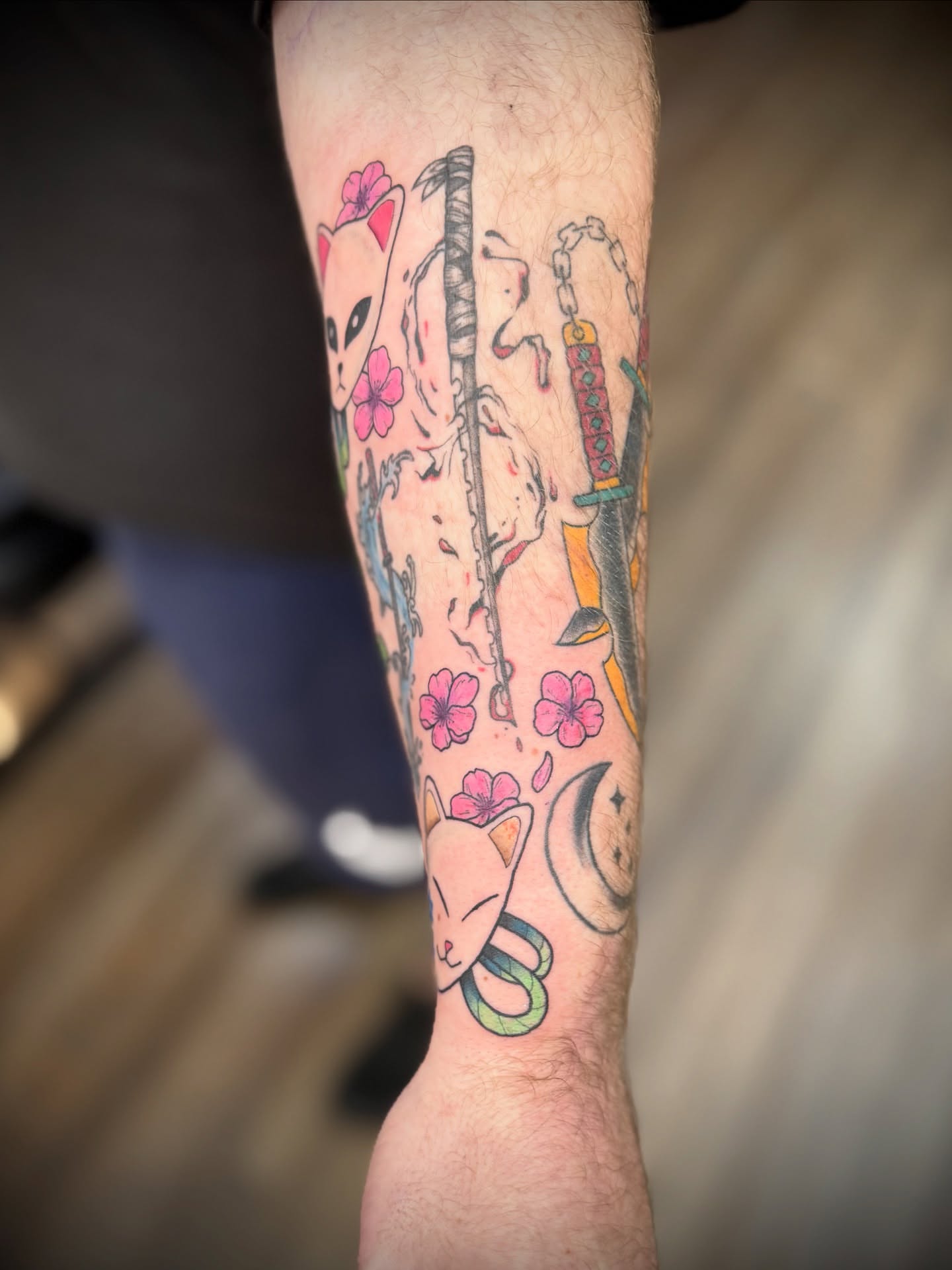 Cat and weapons japanese irezumi tattoo on the forearm by Justin Bianchini - New Orleans Tattoo Artist