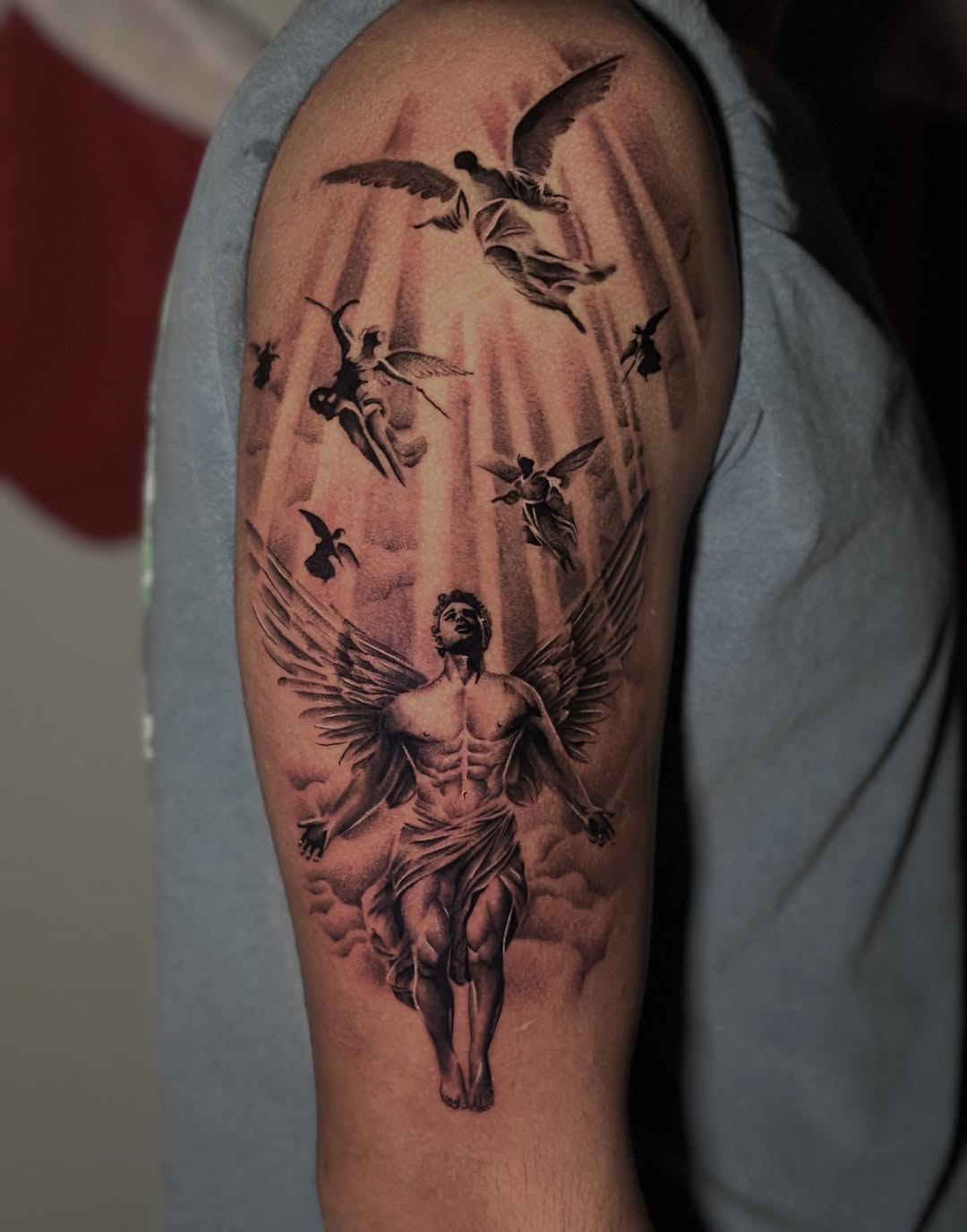 Angelic figures realism tattoo on the forearm by Erika Nambo