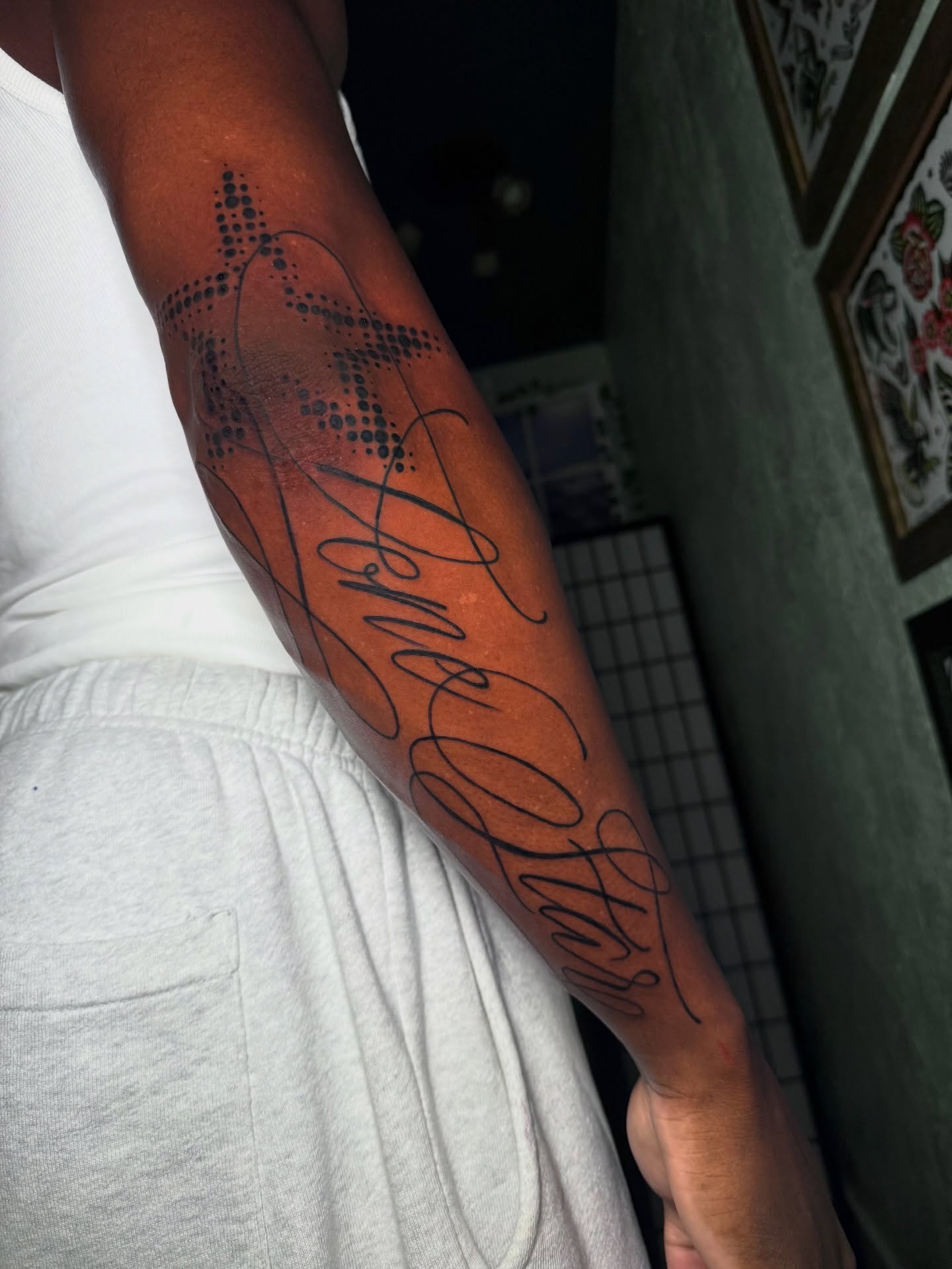 Script lettering dotwork tattoo on the forearm by Carlos Abad