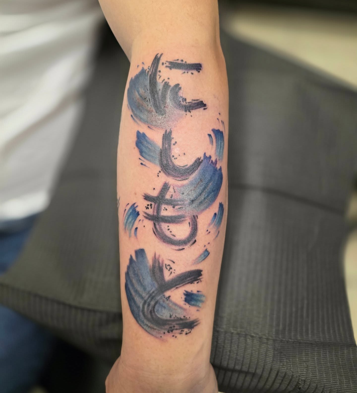 Brush strokes watercolor tattoo on the forearm by Claudia Isabel Roman, El Paso, Texas