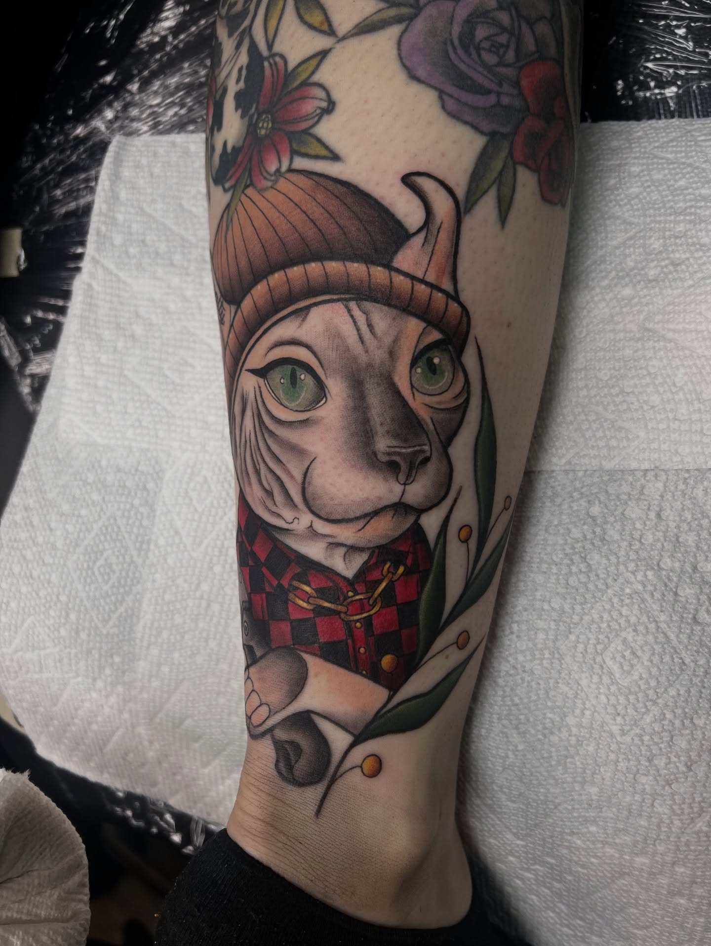 Cat wearing hat realism tattoo on the forearm by Olivia Suzanne Fada