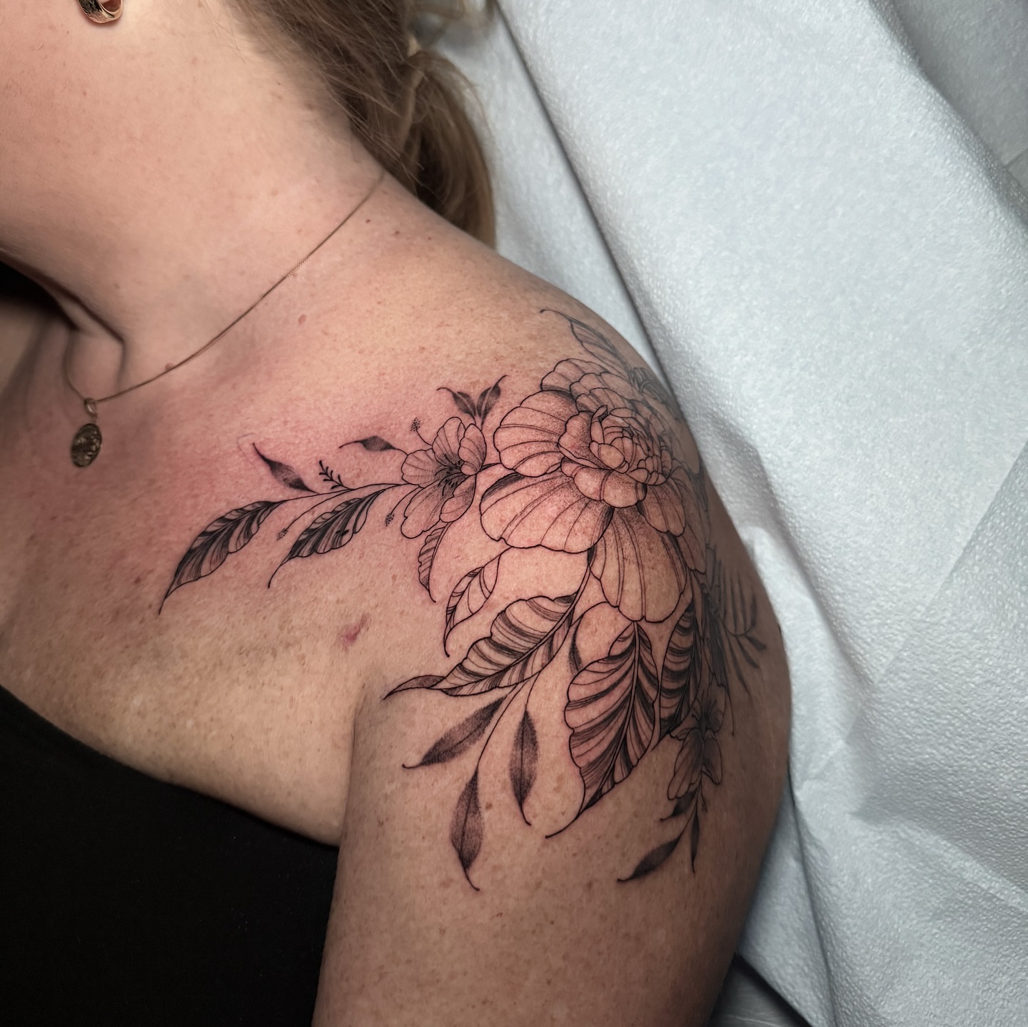 Floral arrangement black and grey tattoo on the shoulder by 𝕹𝖆𝖙