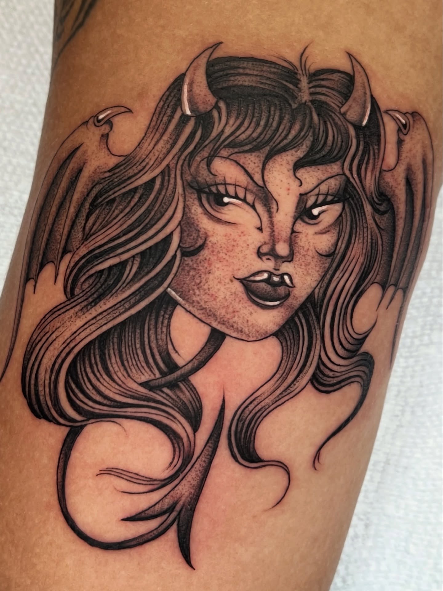 Woman with horns black and grey tattoo on the forearm by Jesus Pieces