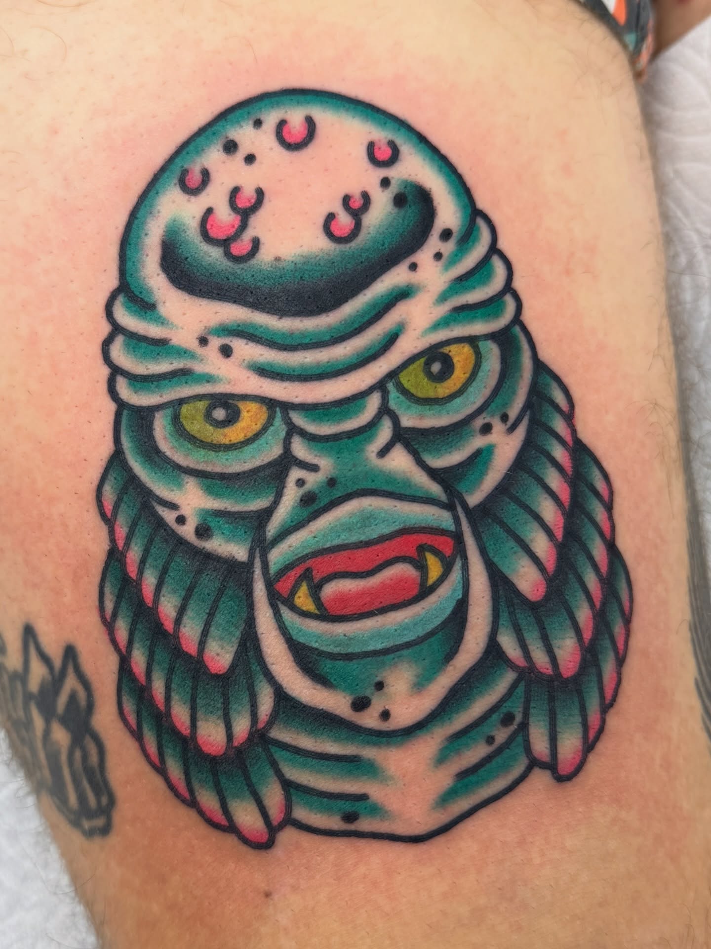 Alien creature American traditional tattoo on the thigh by Joey Burdette Tattoos