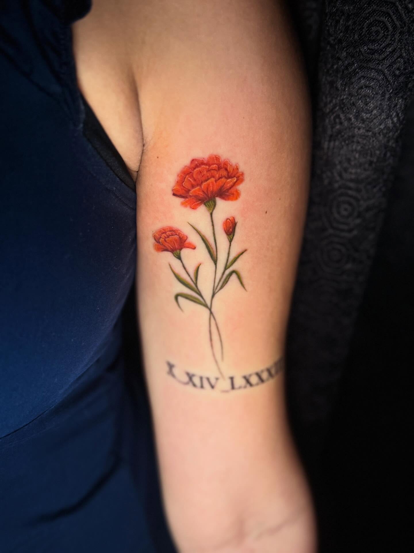 Marigold flowers realism tattoo on the forearm by Nicholas A. Estes-Davis