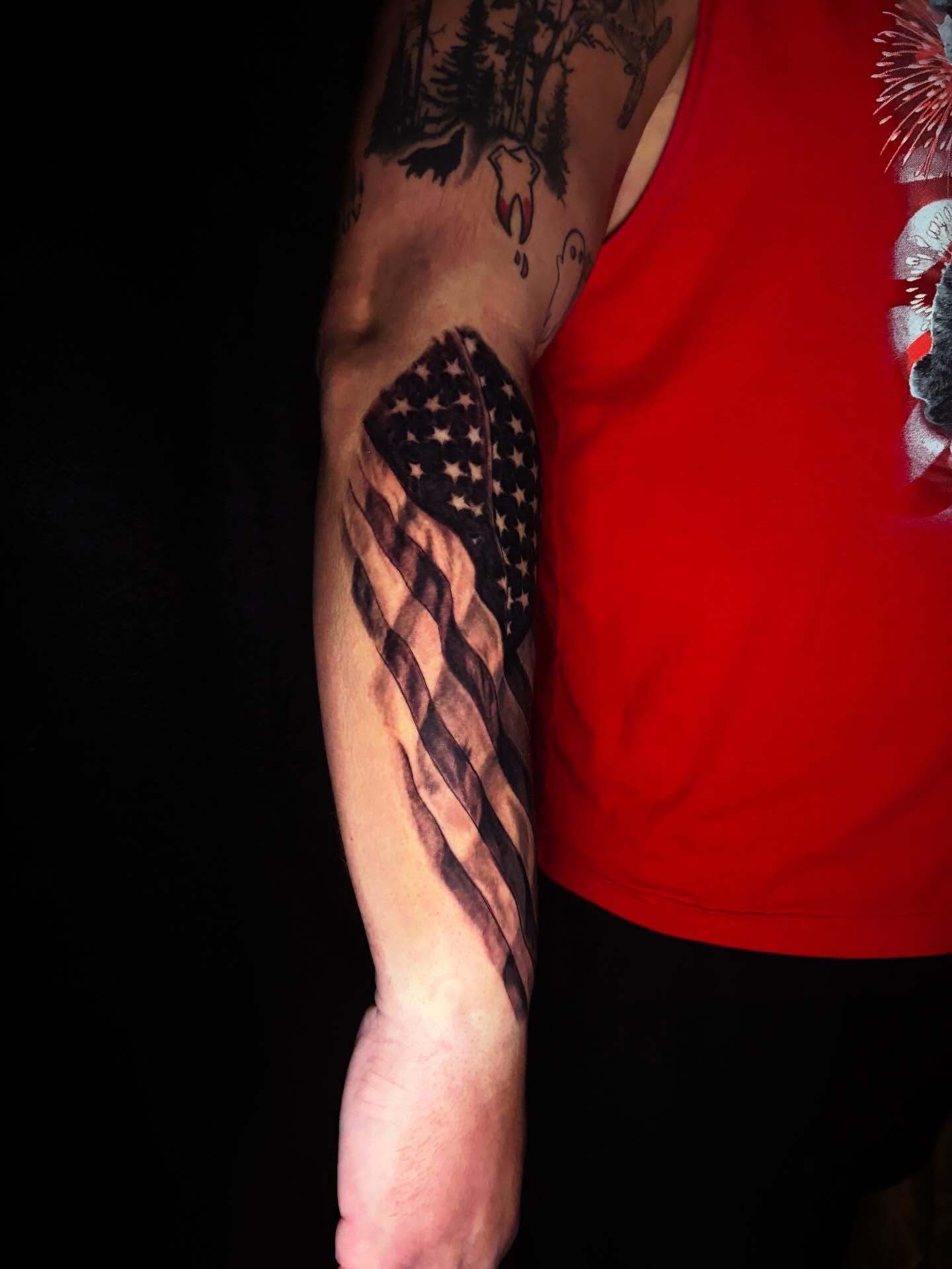 American flag black and grey tattoo on the forearm by Nicholas A. Estes-Davis