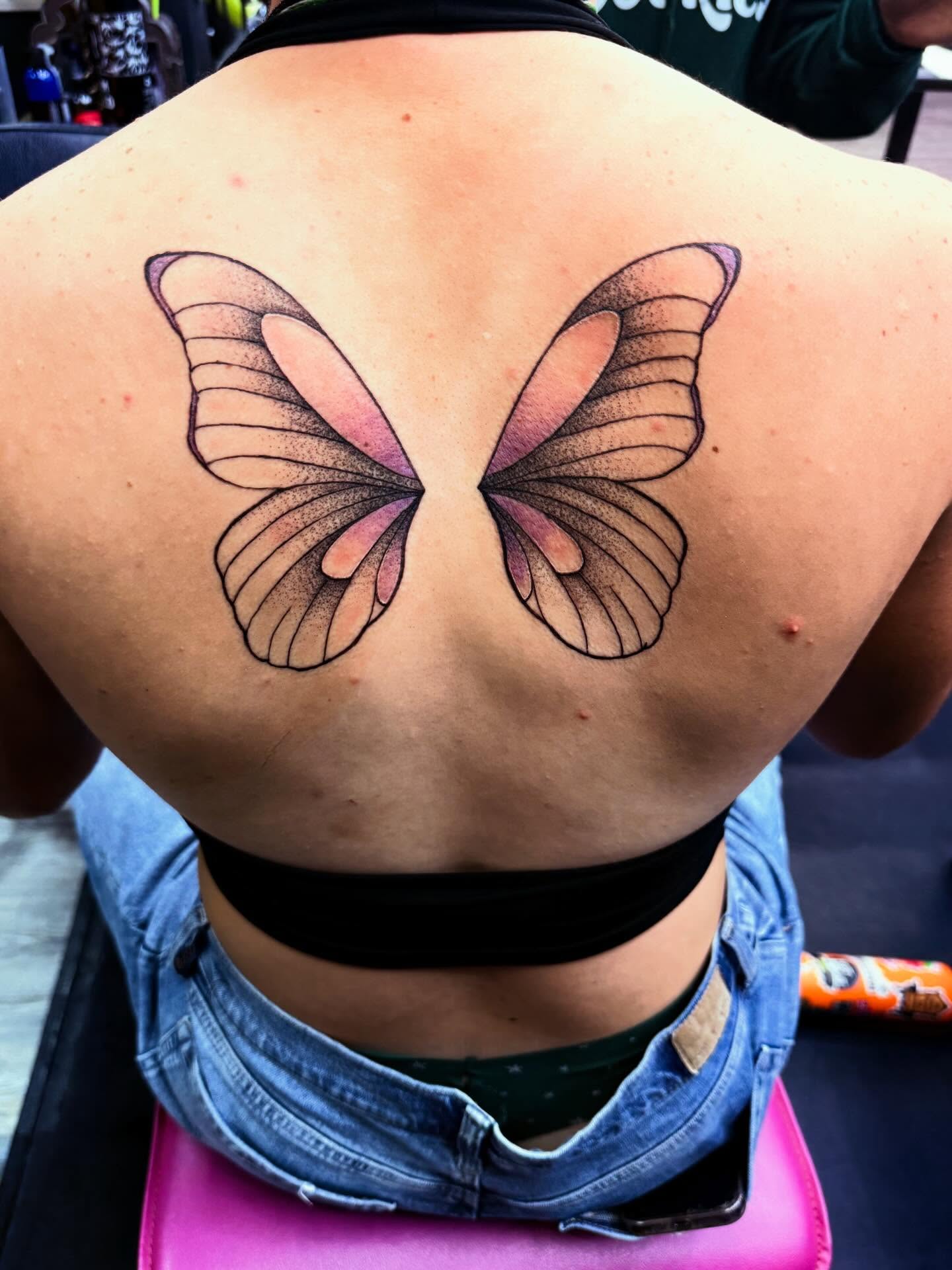 Butterfly dotwork tattoo on the back by Nicholas A. Estes-Davis
