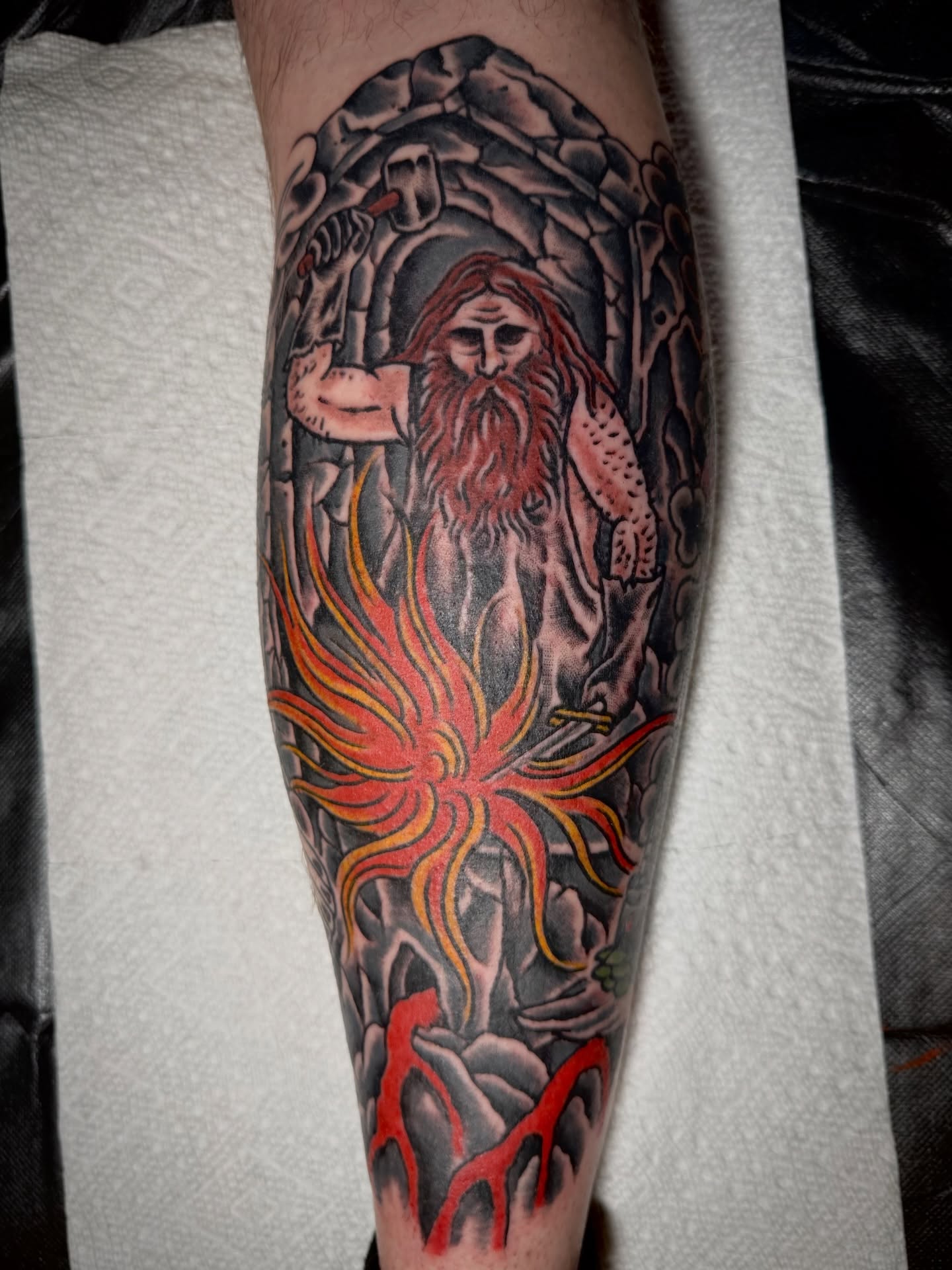 Bearded man with fire realism tattoo on the calf by Jesse Swanson, Santa Rosa, California