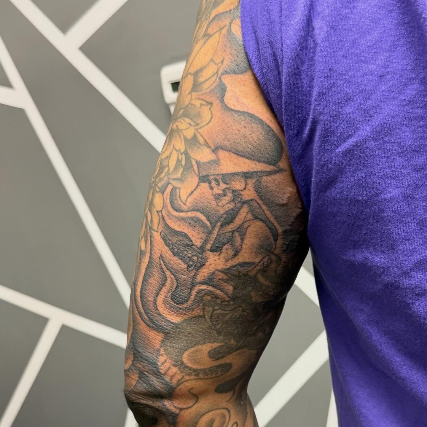 Musician playing guitar American traditional tattoo on the forearm by Katie Rojas