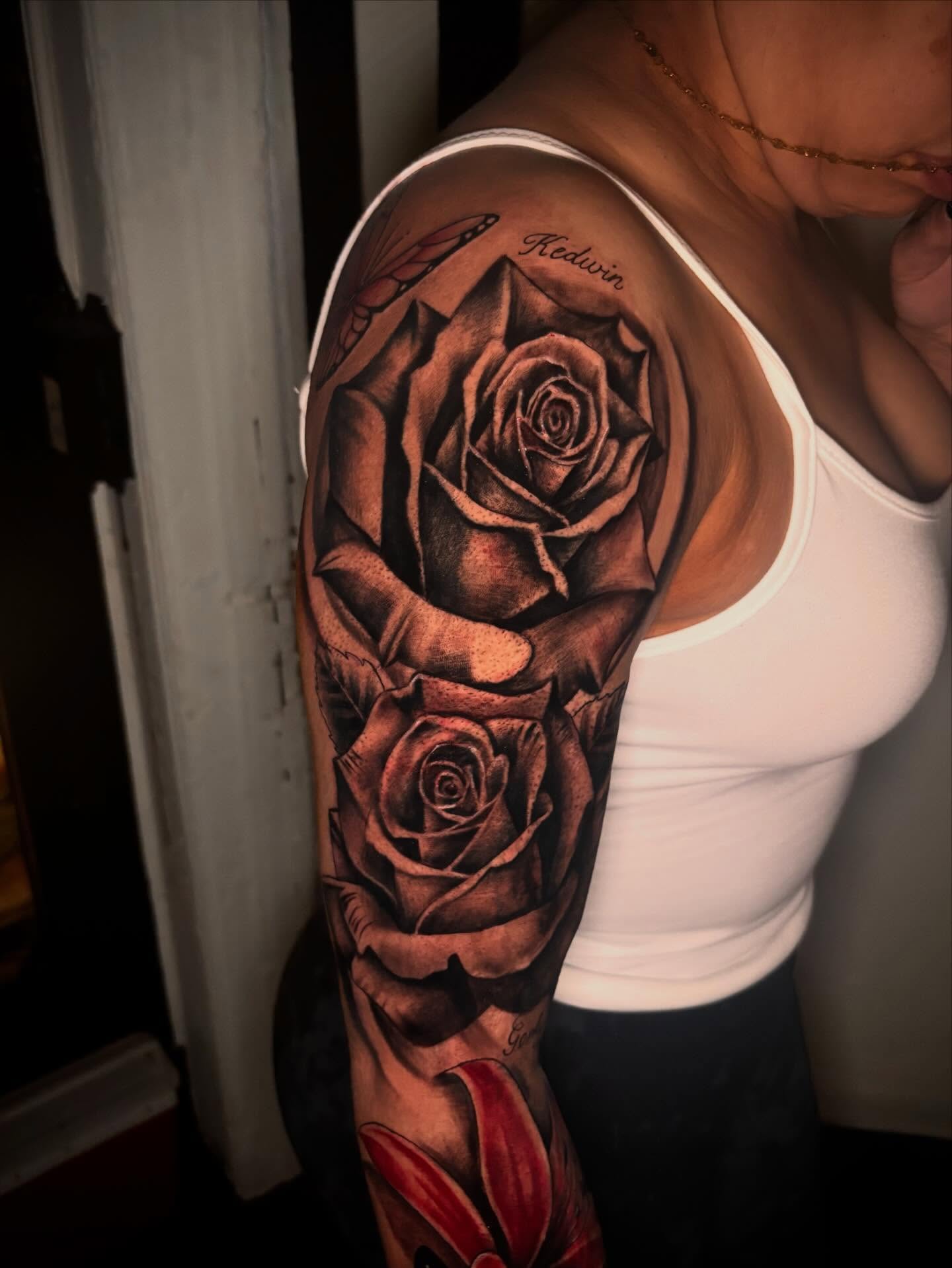 Roses realism tattoo on the upper arm by Daero Tattoo, New York, New York