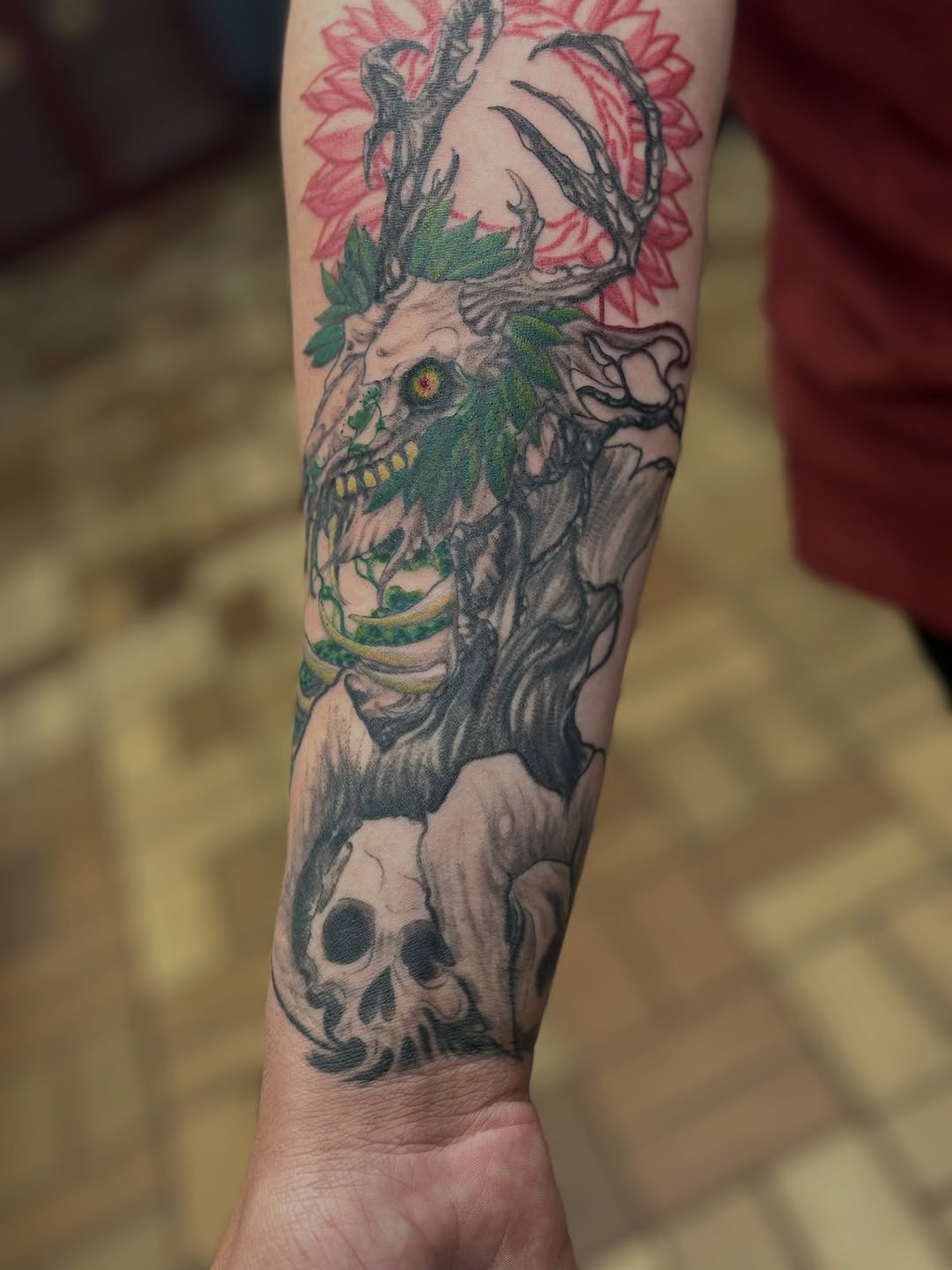 Deer skull with antlers and flowers dark art tattoo on the forearm by vannadoestattoos
