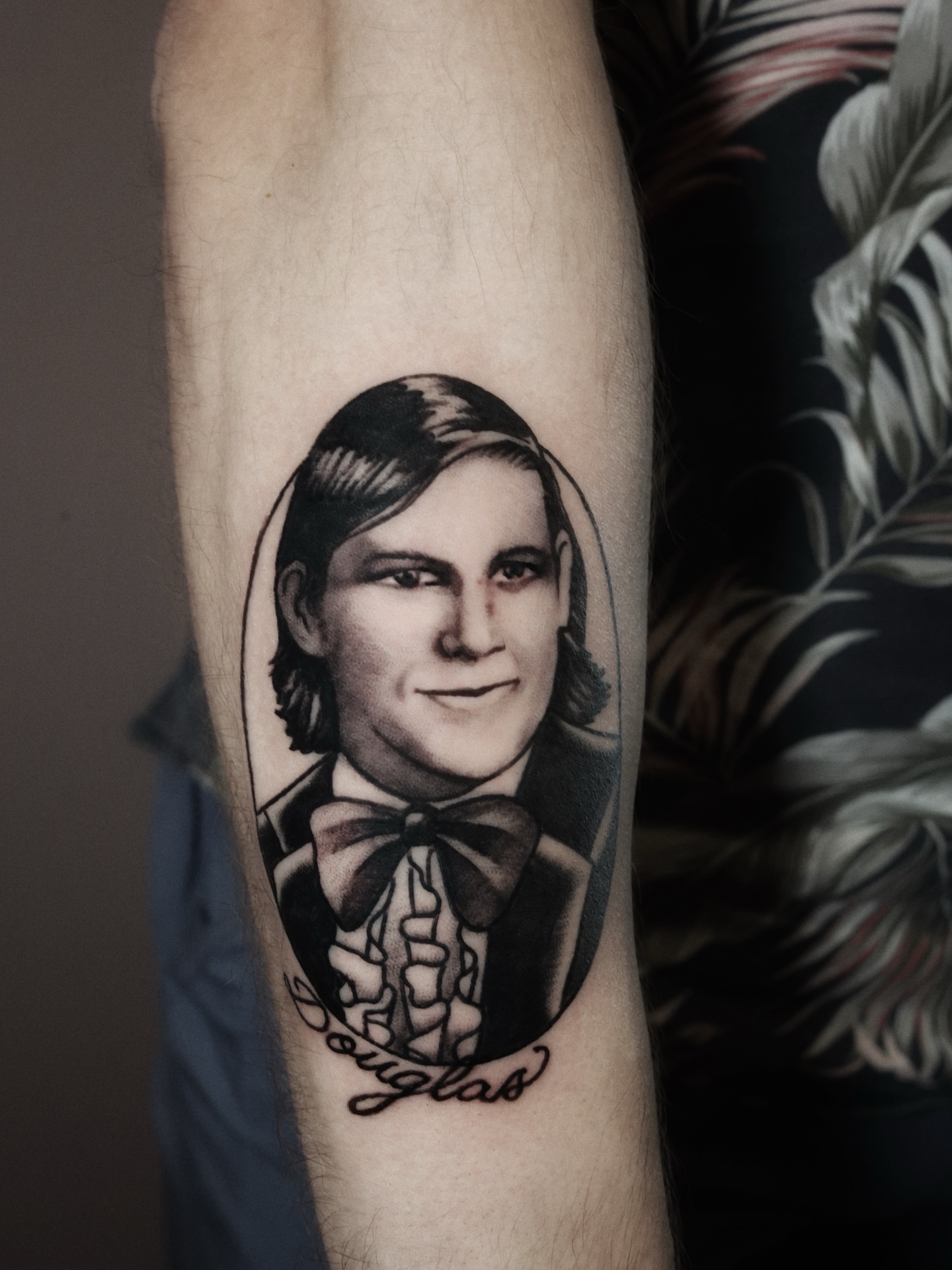 Portrait realism tattoo on the forearm by Dylan Mott