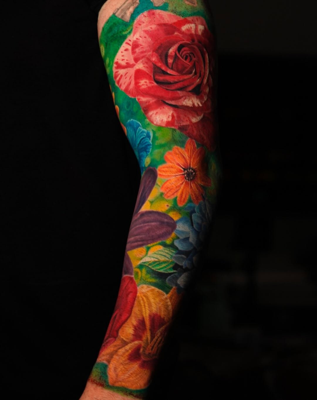 Floral sleeve neo-traditional tattoo on the forearm by David Gordon