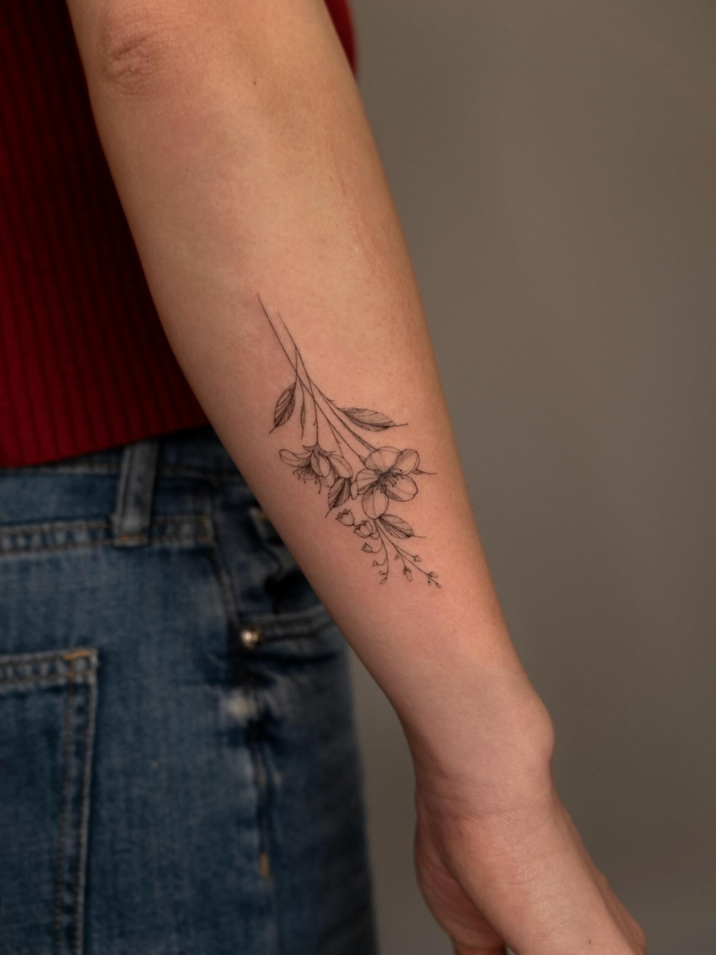 Flower branch fine line tattoo on the forearm by ๐๐๐ฆ ๐๐ ๐ฎ๐ฒ๐๐ง