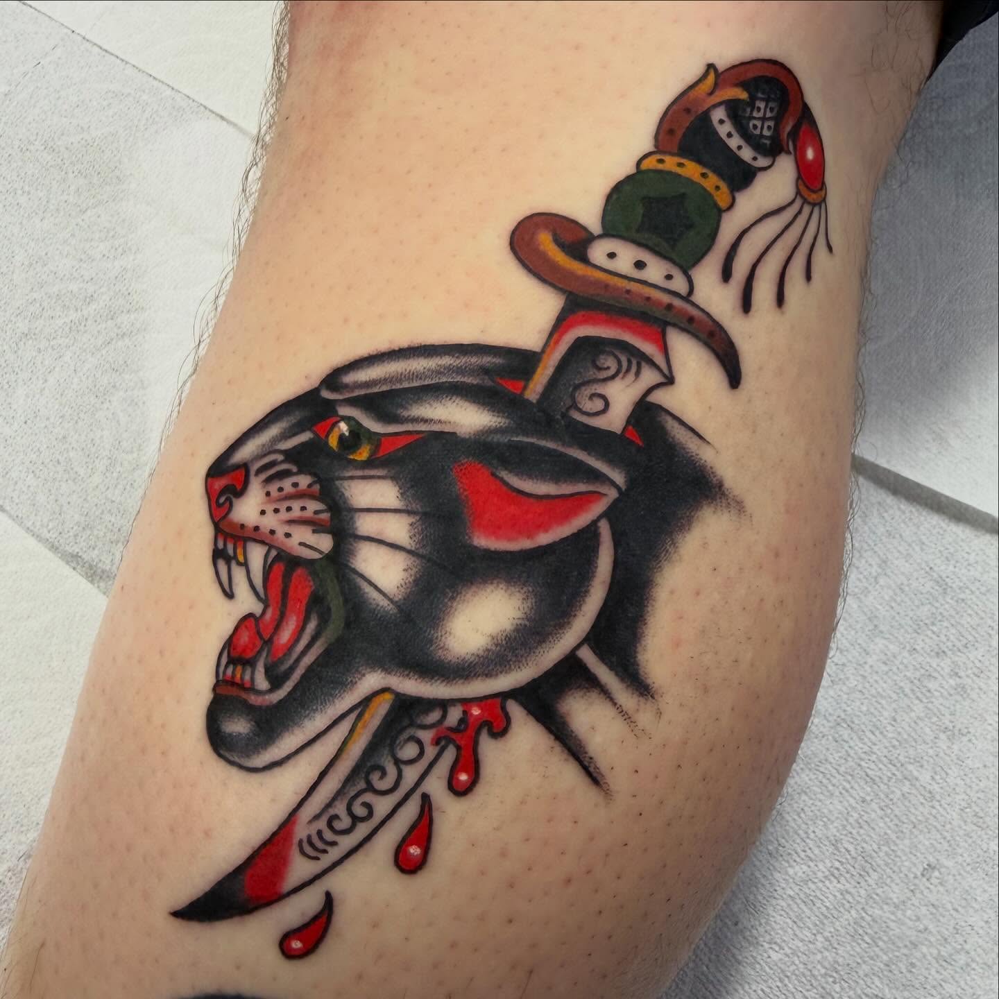 Panther and dagger American traditional tattoo on the forearm by David Evans
