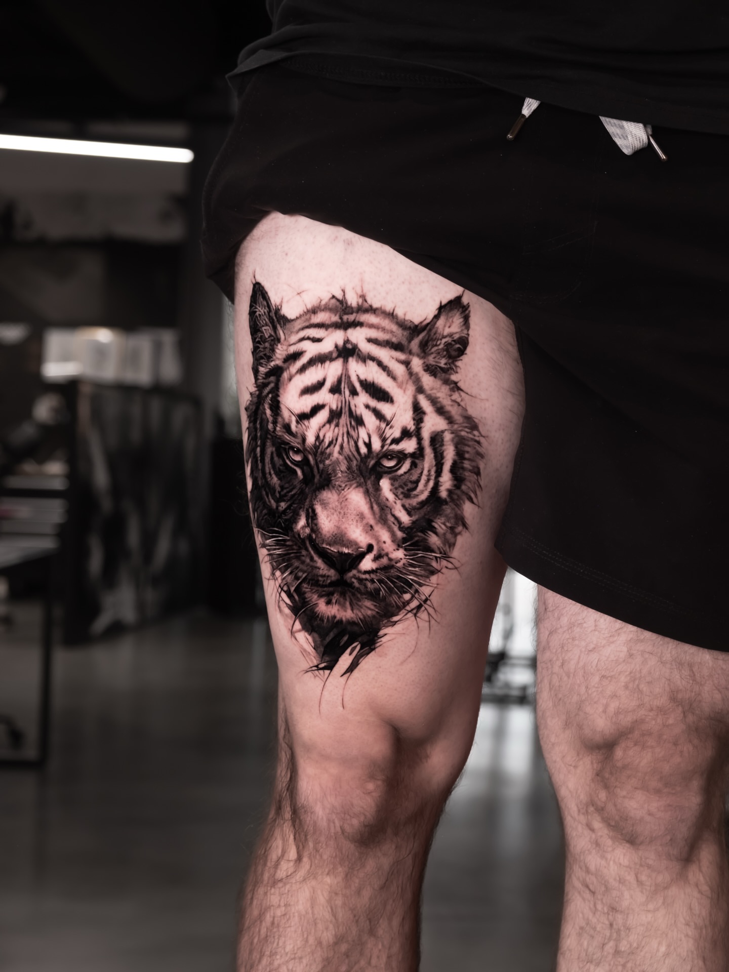 Tiger realism tattoo on the thigh by Anastasia Ritova