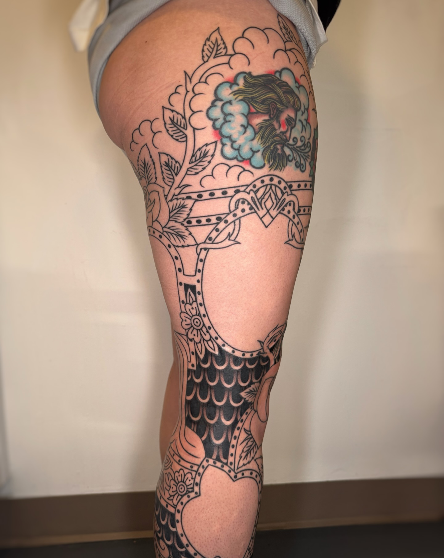 Peacock and floral American traditional tattoo on the thigh by Cori James Tattoo Artist