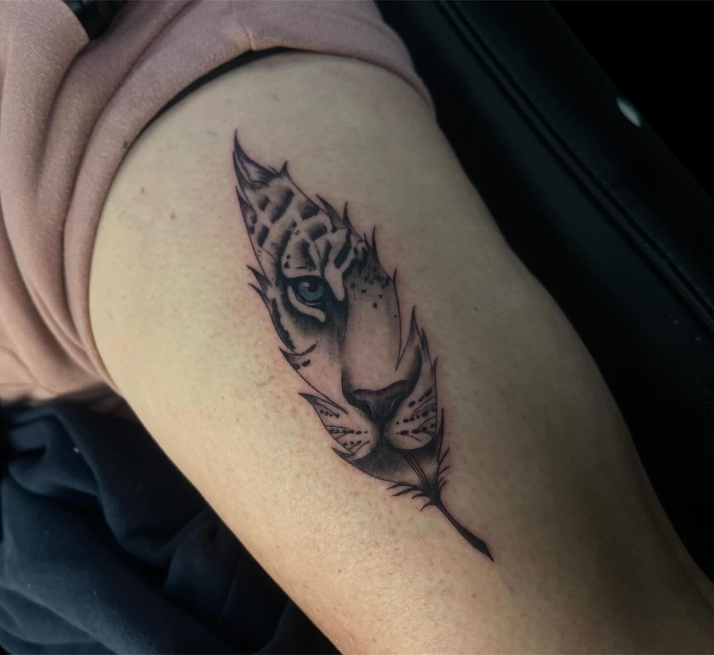 Tiger black and grey tattoo on the thigh by Brooke Kresco
