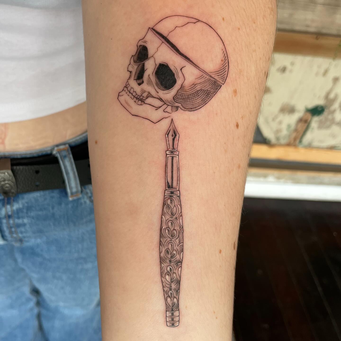 Skull and fountain pen realism tattoo on the forearm by Ally Easter, Berkeley, California