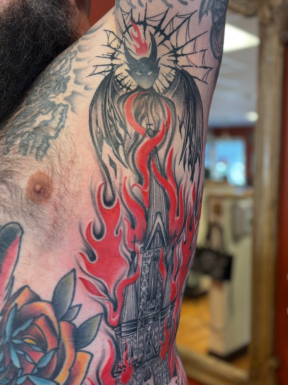 Burning church American traditional tattoo on the upper arm by Dee - MA Tattoo Artist, Concord, Massachusetts