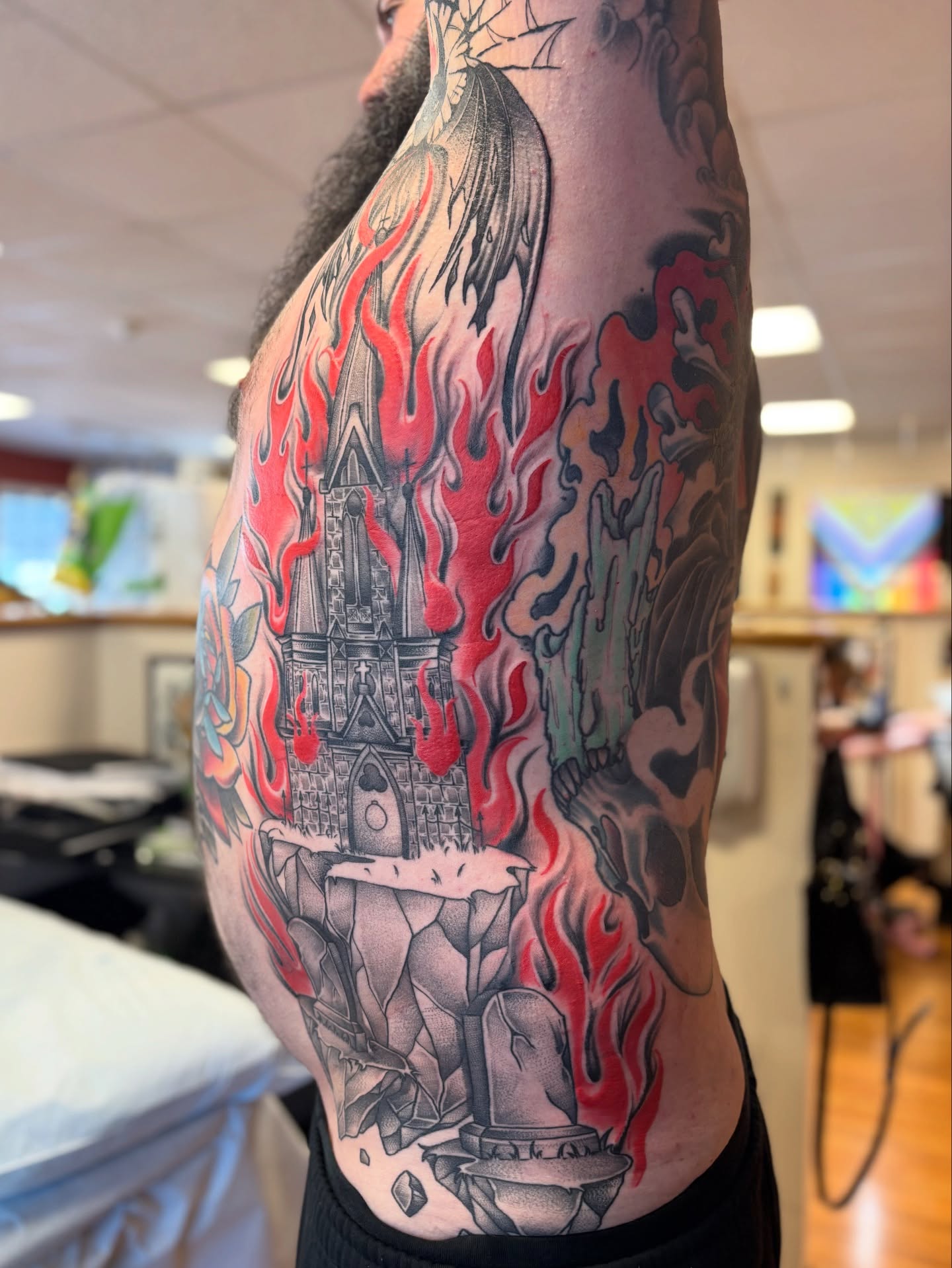 Burning castle neo-traditional tattoo on the ribs by Dee - MA Tattoo Artist, Concord, Massachusetts