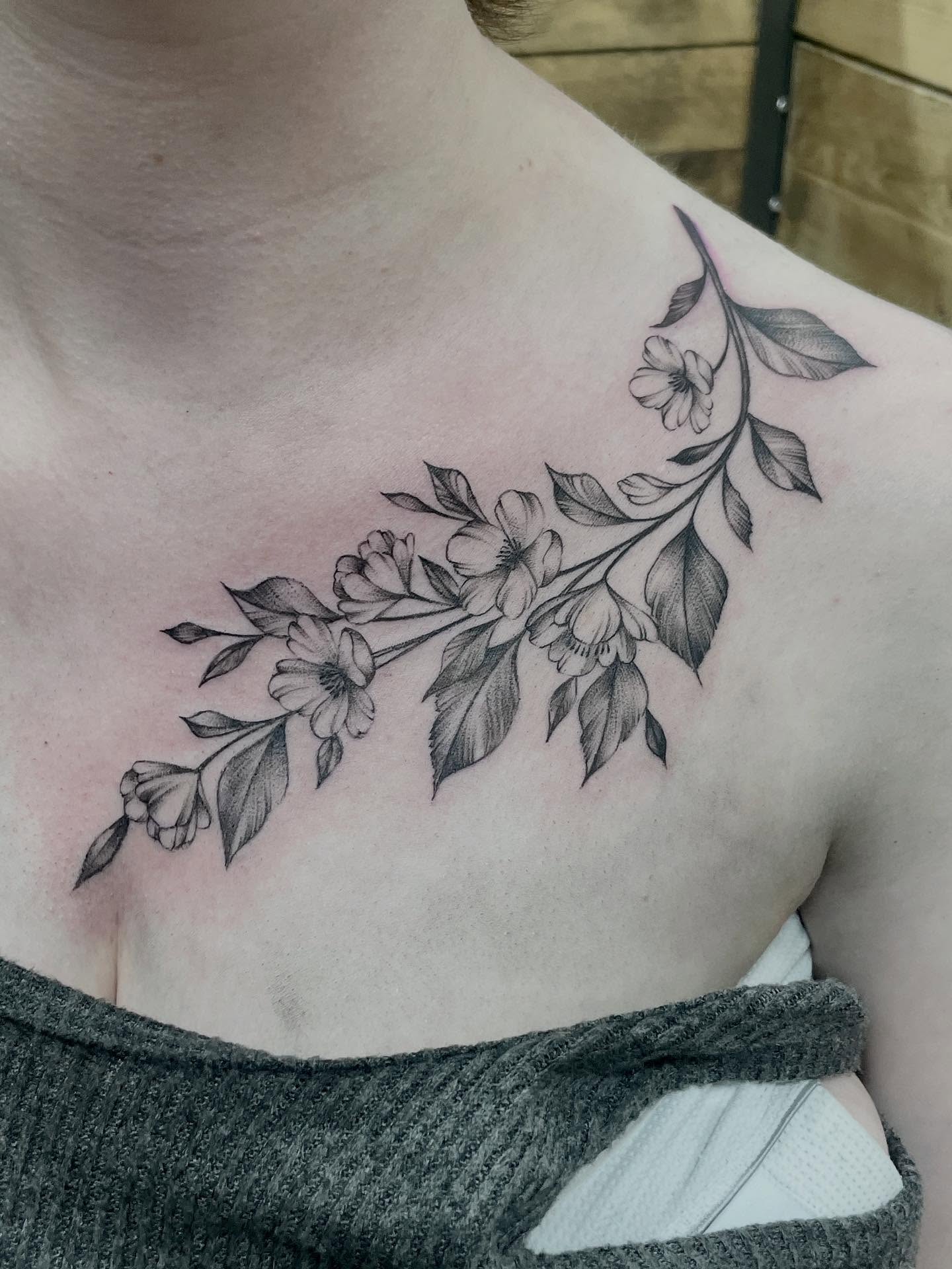 Flower branch black and grey tattoo on the shoulder by Grace derby tattooist, Derby