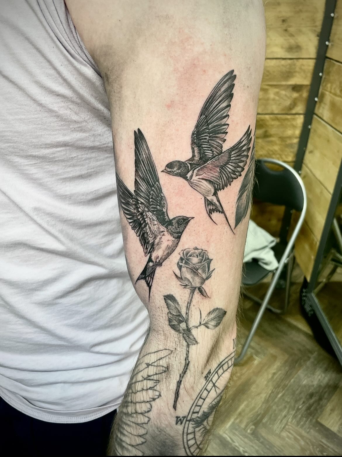 Birds and rose black and grey tattoo on the forearm by Grace derby tattooist, Derby