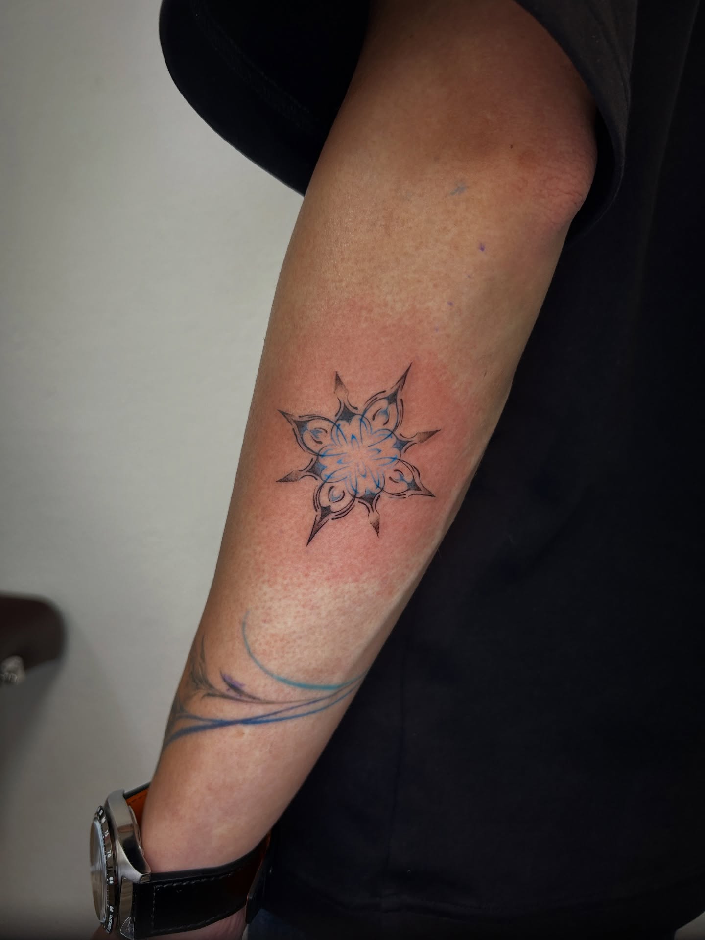 Geometric star geometric tattoo on the forearm by Miri